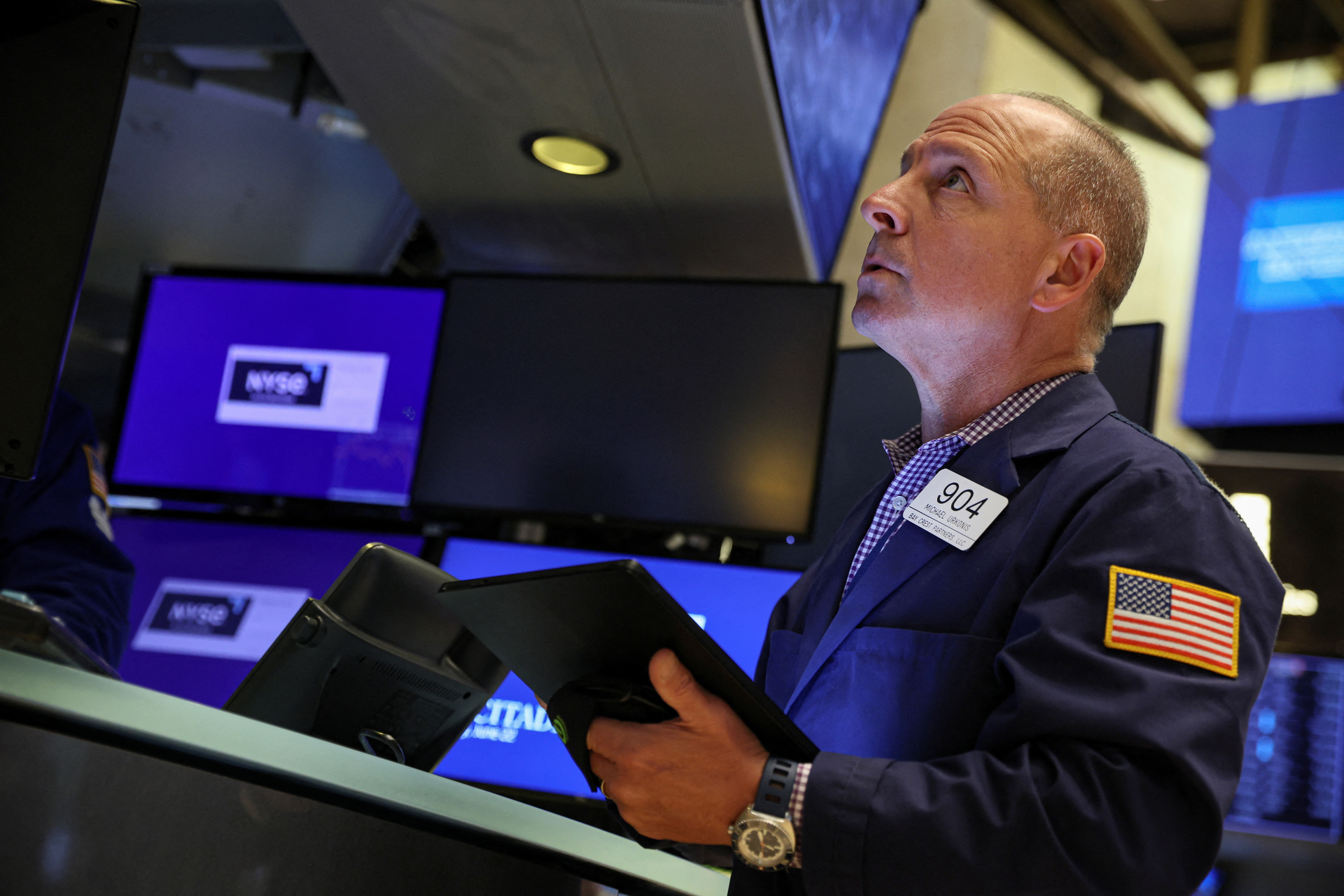 Traders work on the floor of the NYSE in New York