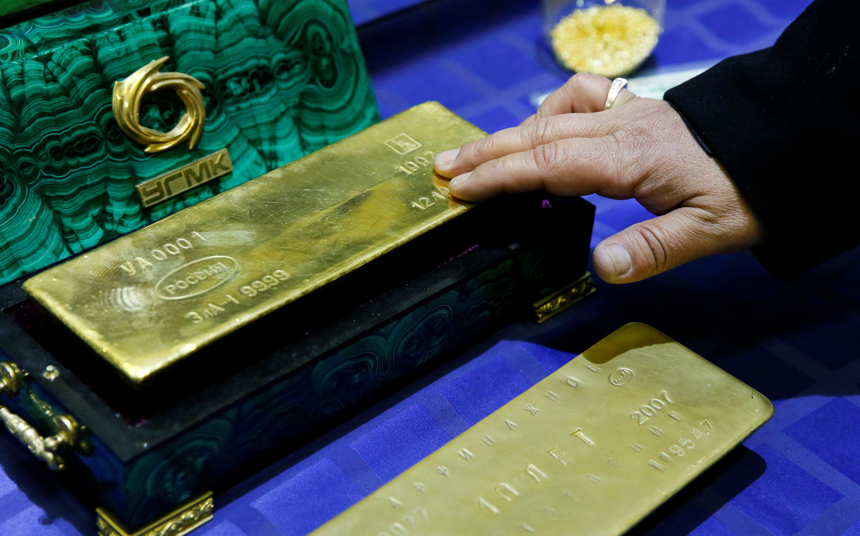 Employee displays a gold bar at a gold refining workshop of the plant of Uralelektromed Joint Stock Company, the enterprise of Ural Mining and Metallurgical company in the town of Verkhnyaya Pyshma