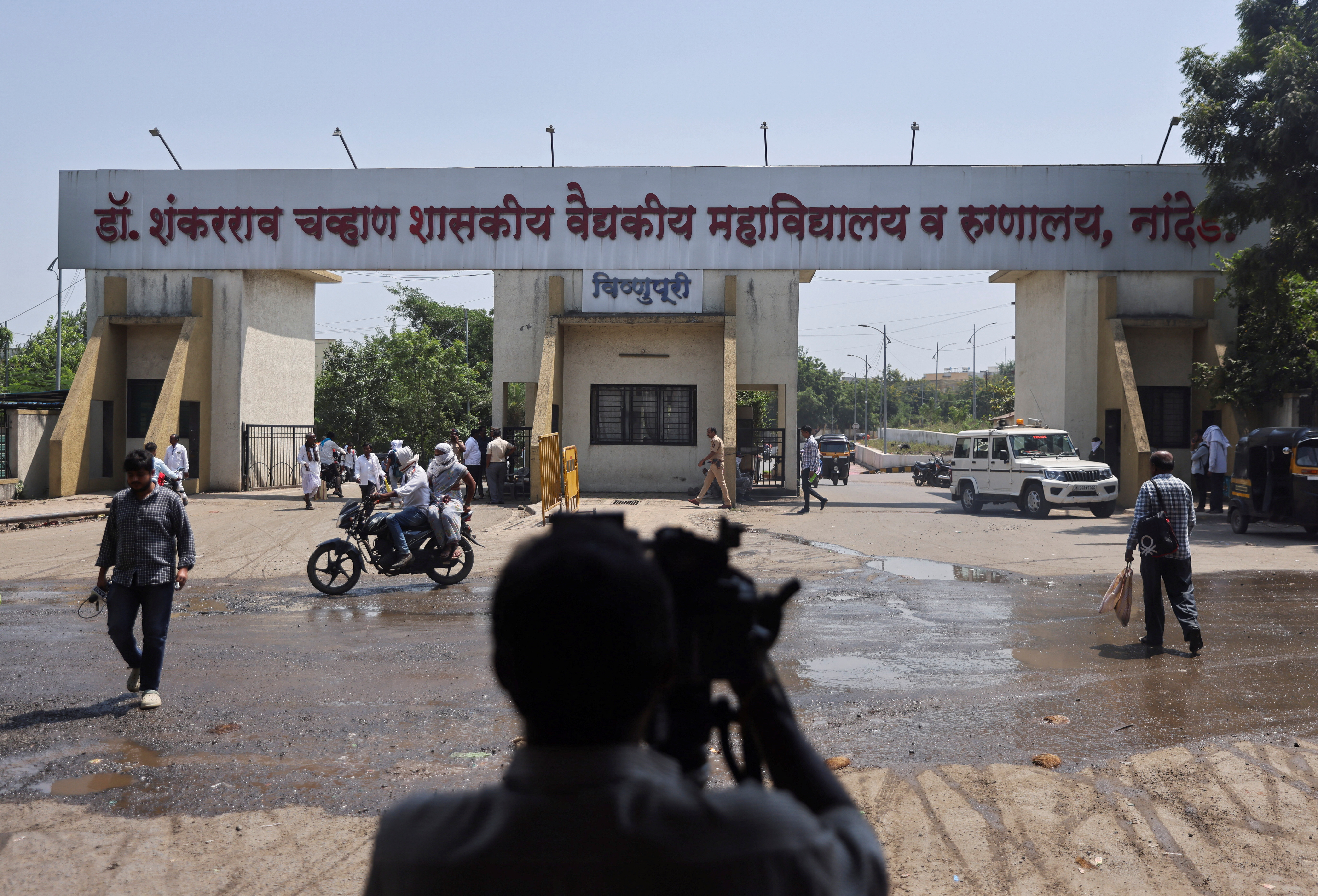 A media member takes a video outside the main gate of the Shankarrao Chavan Government Medical College and Hospital in Nanded