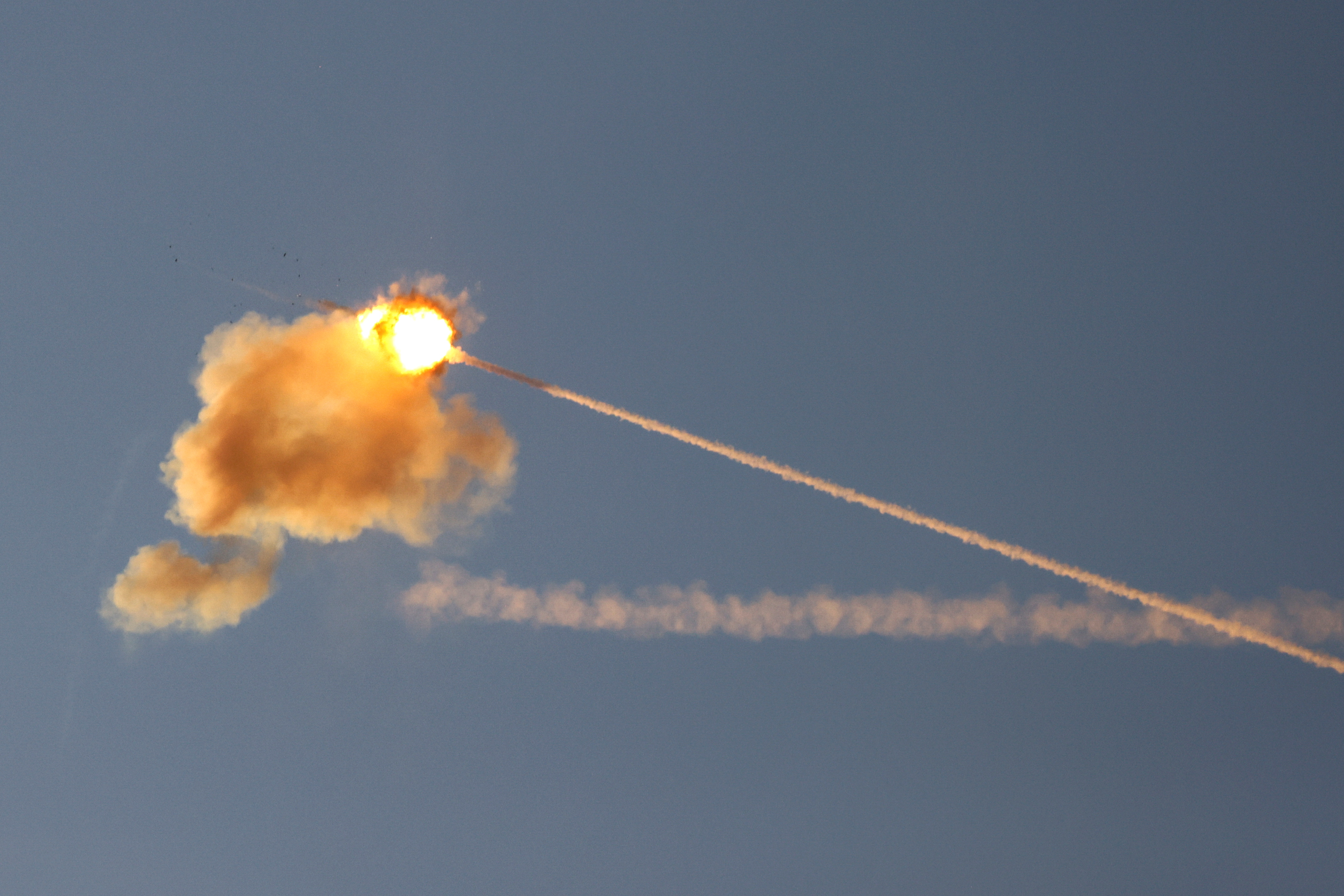 An explosion is seen midair as Israel's Iron Dome anti-missile system intercepts a rocket launched from the Gaza Strip May 17, 2021. REUTERS/Amir Cohen