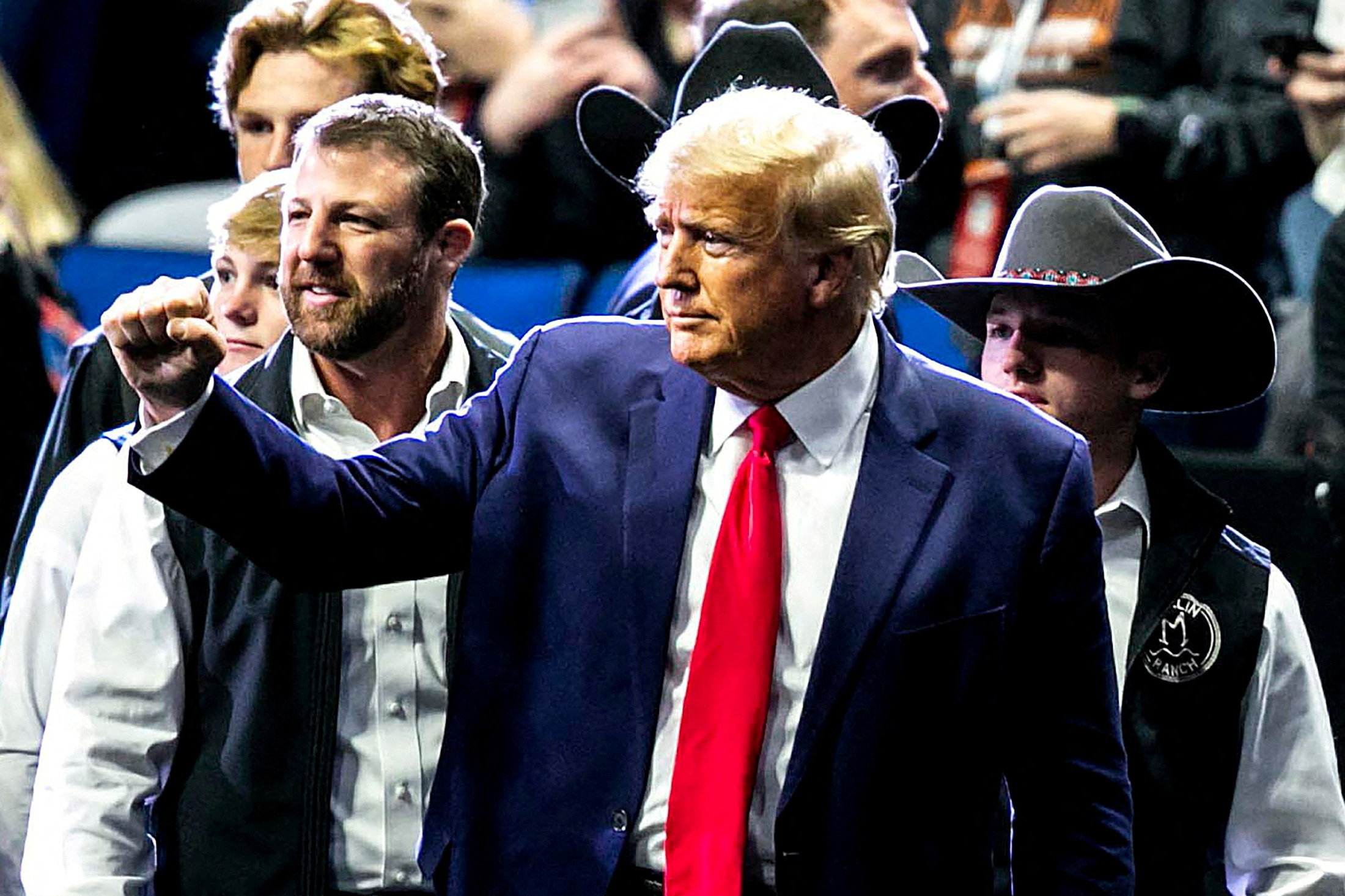 Former President Donald Trump greets fans as he arrives at NCAA Wrestling Championships