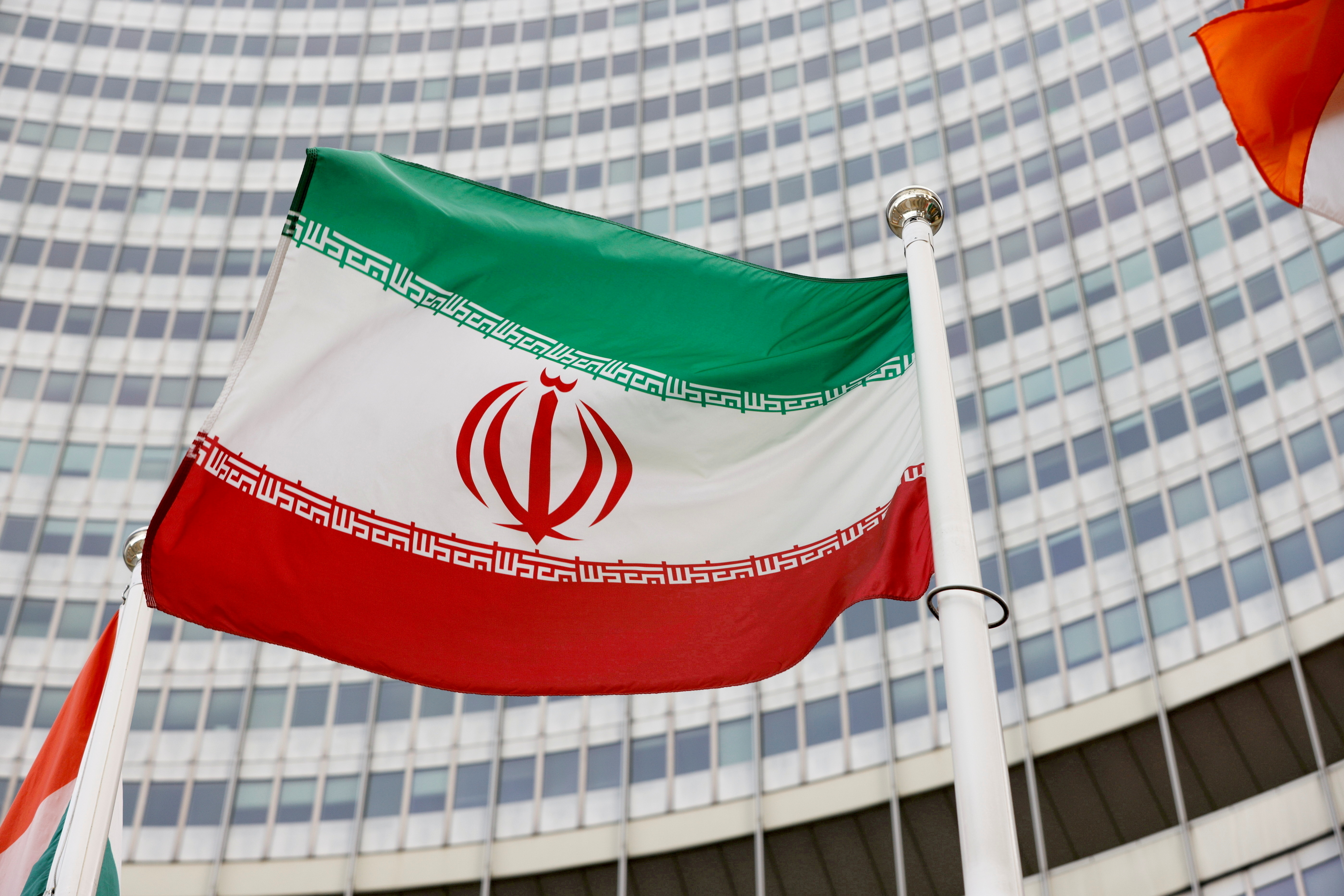 The Iranian flag waves in front of the International Atomic Energy Agency (IAEA) headquarters in Vienna, Austria May 23, 2021. REUTERS/Leonhard Foeger
