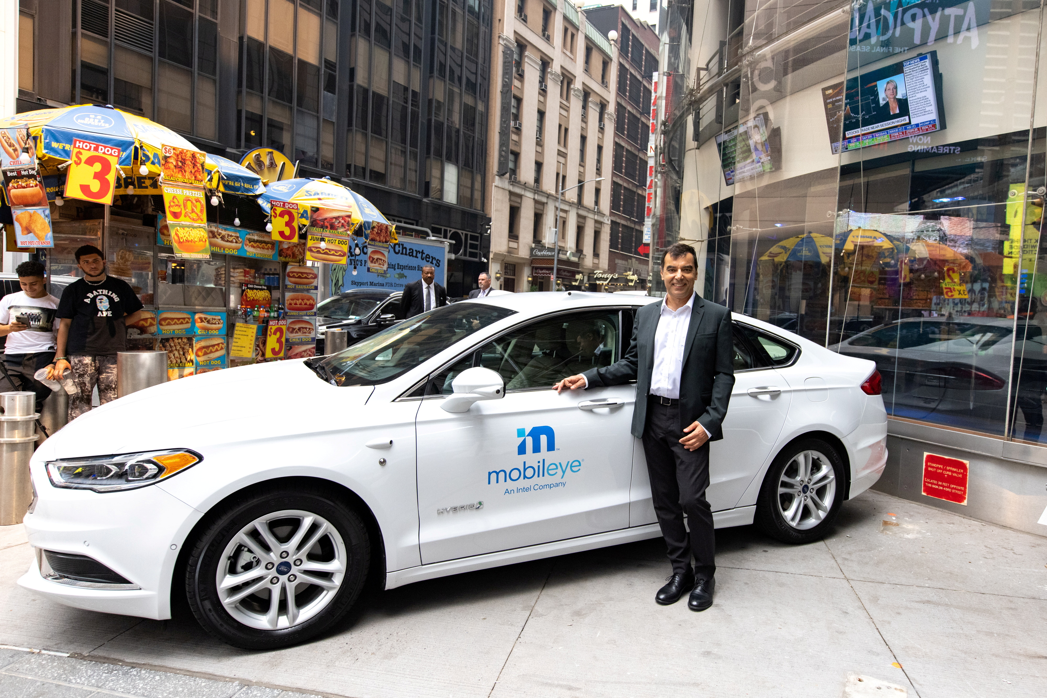Mobileye’s CEO Amnon Shashua poses with a Mobileye driverless vehicle at the Nasdaq Market site in New York, U.S., July 20, 2021. REUTERS/Jeenah Moon/File Photo