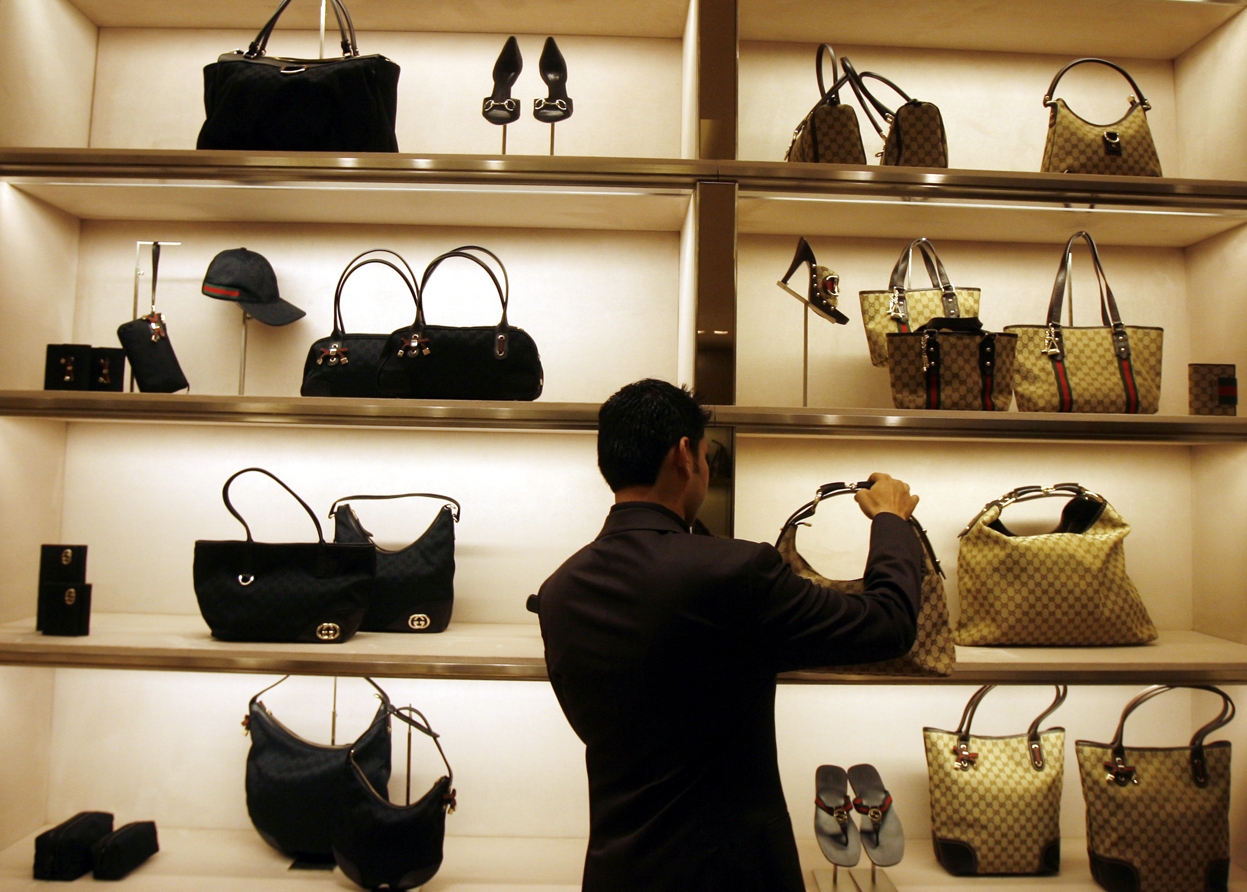 An employee arranges bags at a Gucci showroom in Mumbai