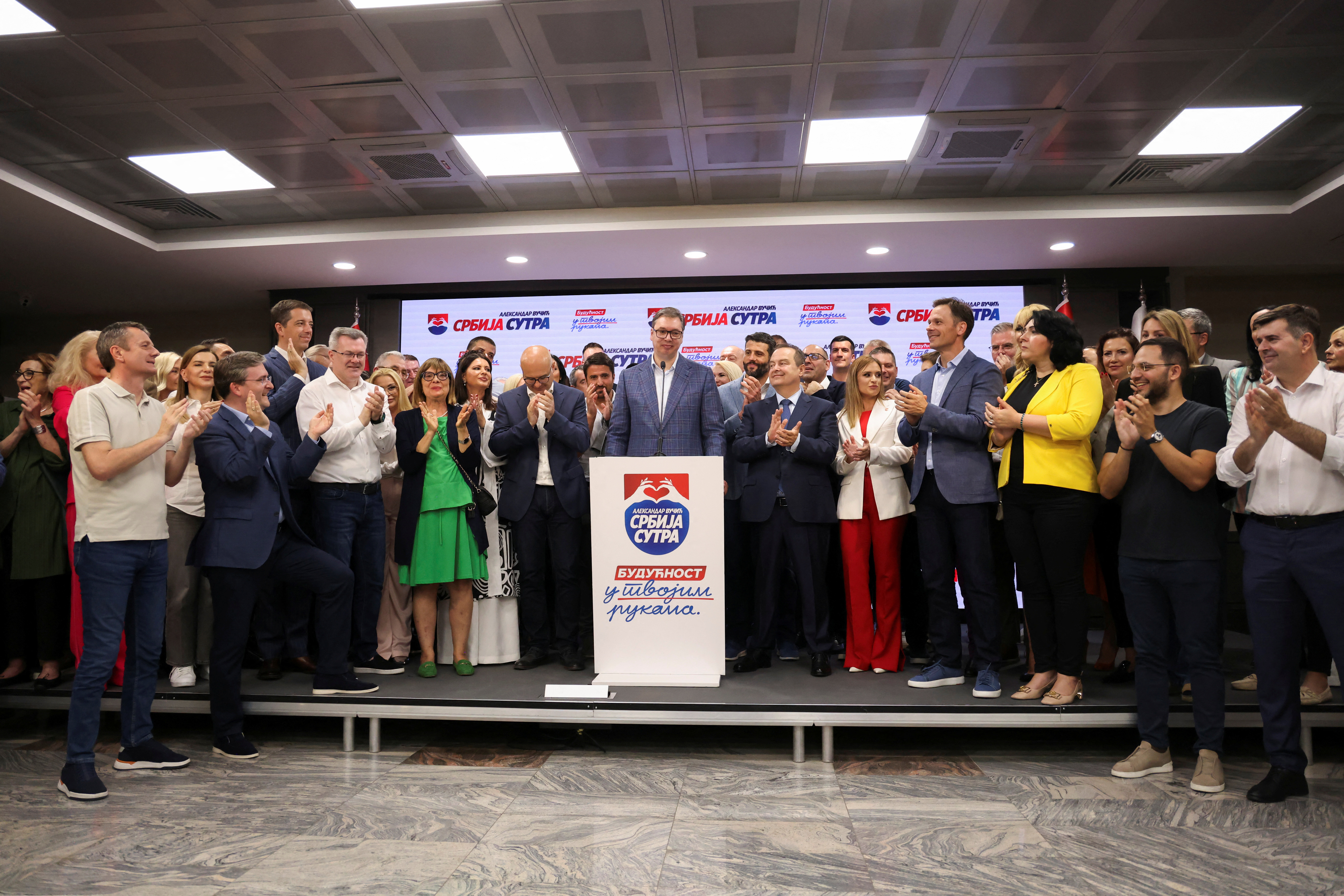 Serbian President Aleksandar Vucic speak on stage at Serbian Progressive Party (SNS) headquarters following exit polls