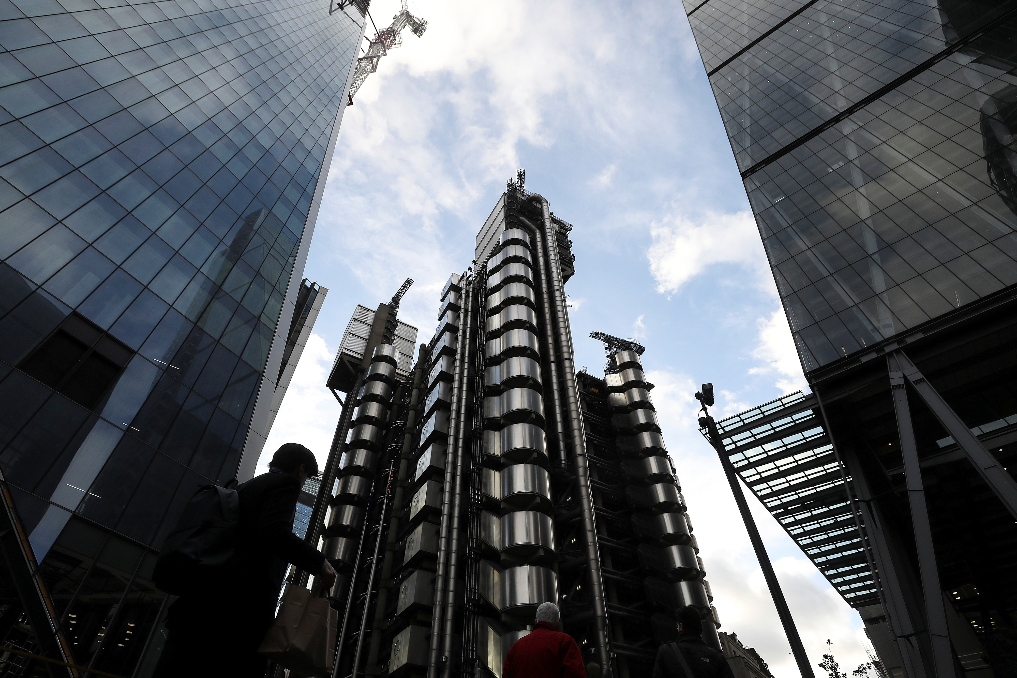 The Lloyd's of London building is lit by winter sun in the City of London financial district in London