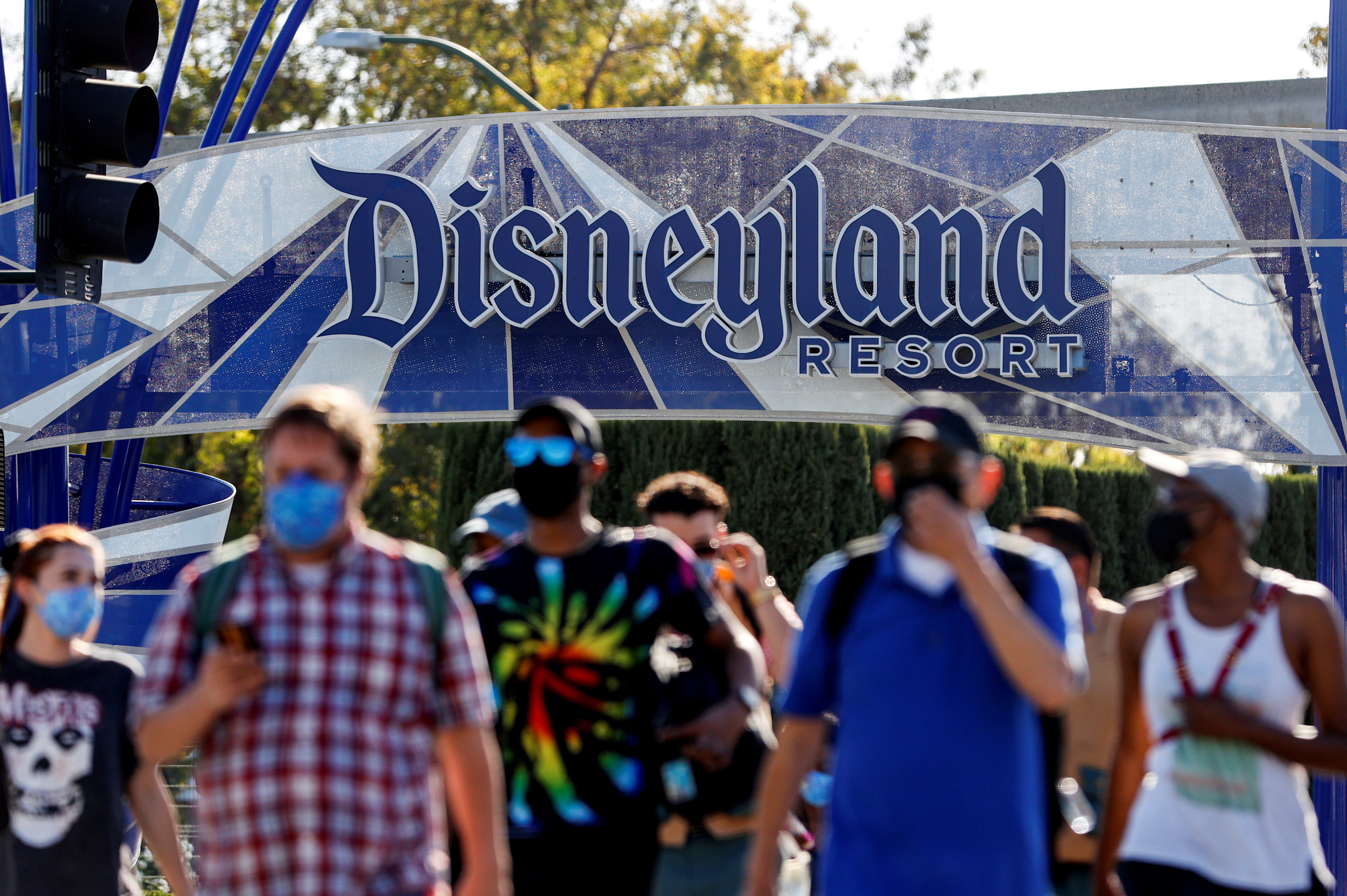 FILE PHOTO: People leave the Disneyland Resort on Disneyland Park and Disney California Adventure's reopening day amidst the coronavirus disease (COVID-19) outbreak, in Anaheim, California, U.S., April 30, 2021. REUTERS/Mario Anzuoni