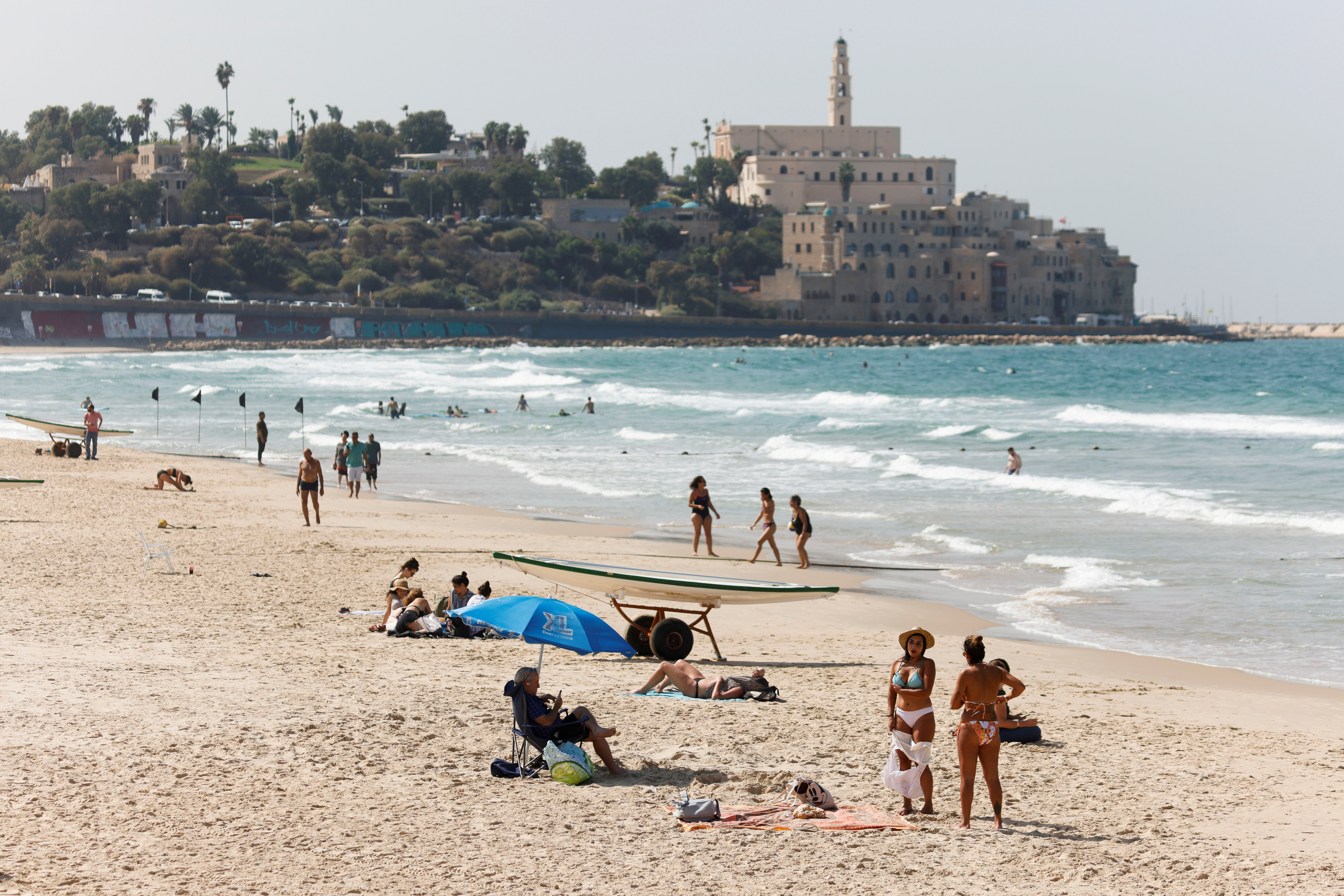 People hang out at the Mediterranean beach near Jaffa as coronavirus disease (COVID-19) restrictions ease in Tel Aviv