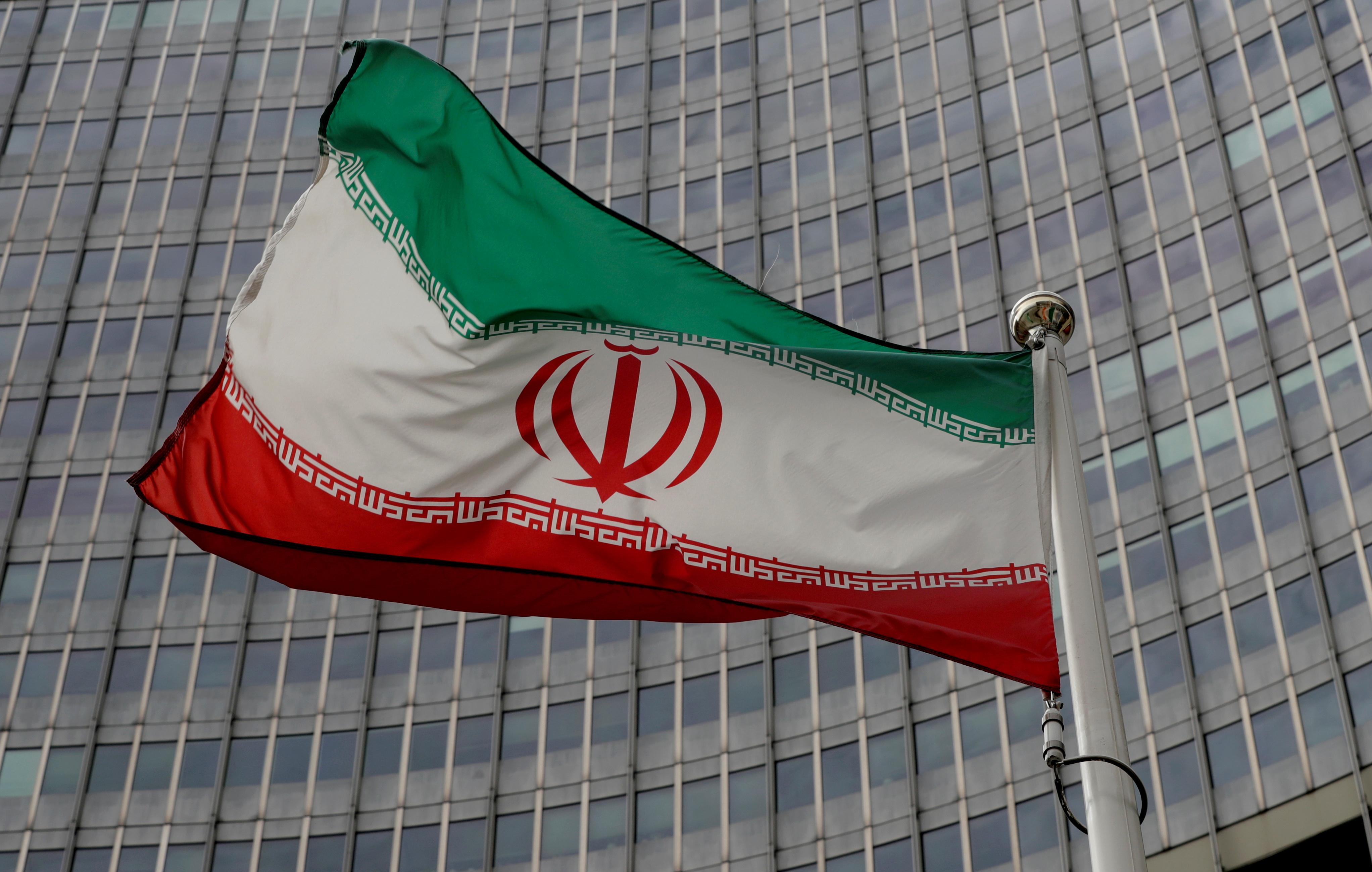 An Iranian flag flutters in front of the International Atomic Energy Agency (IAEA) headquarters in Vienna, Austria, September 9, 2019.   REUTERS/Leonhard Foeger
