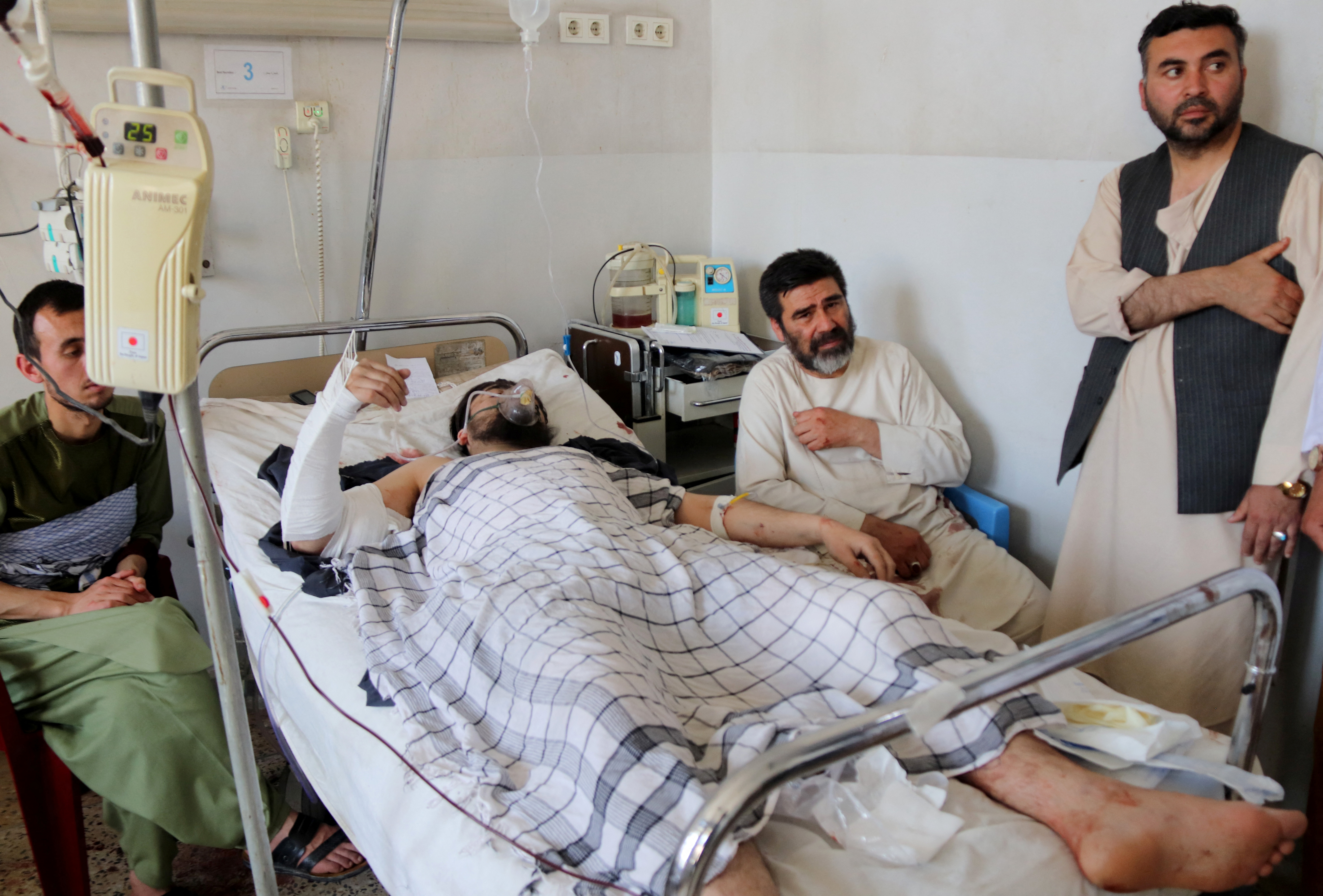 An Afghan man receives treatment in a hospital after he was injured in an explosion at a Shi'ite mosque in Mazar-e-Sharif