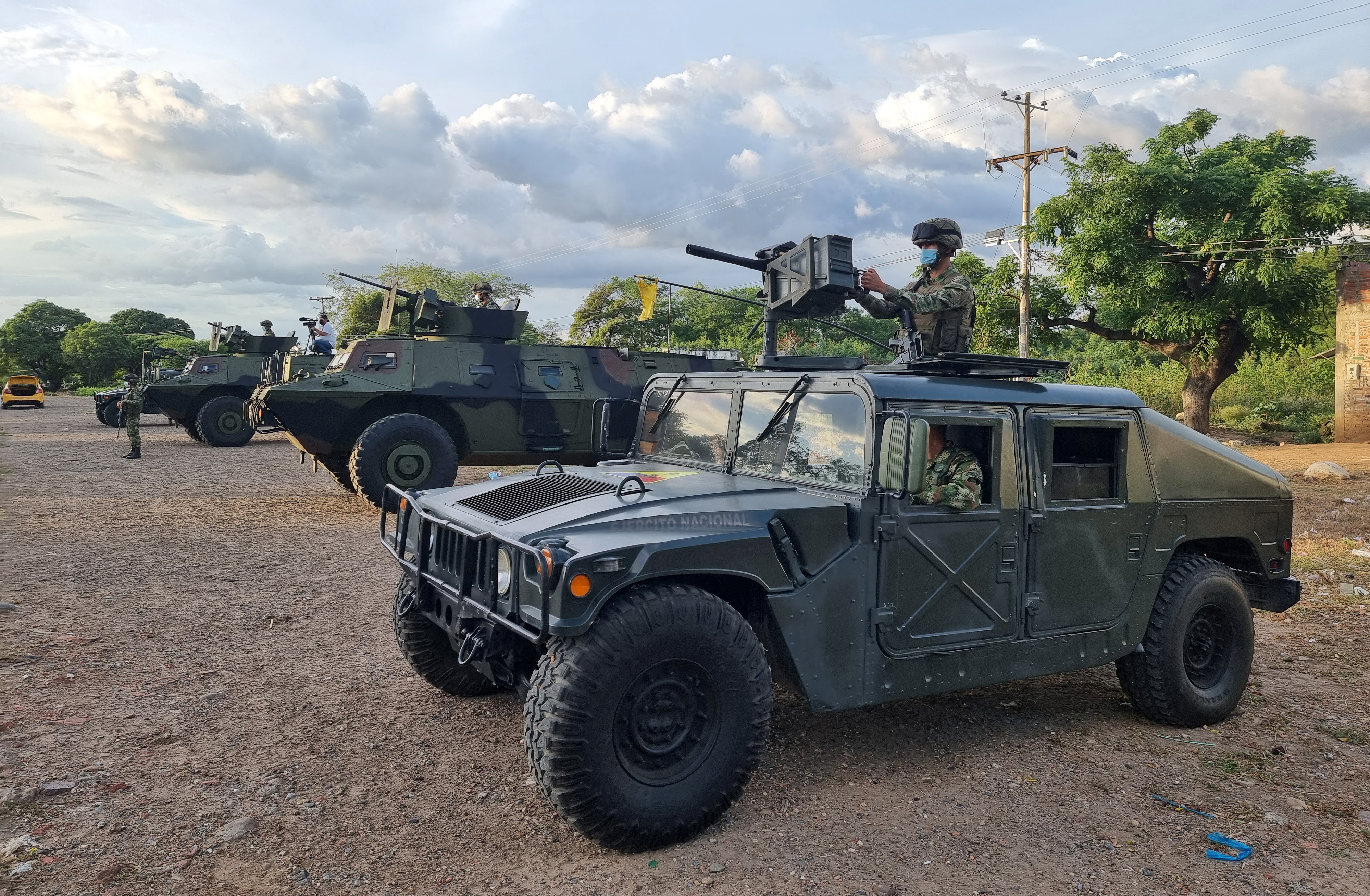 Members of the Colombian military patrol between Colombia and Venezuela by an unofficial crossing, as Venezuela reopens its borders with Colombia after a nearly three-year closure due to political tensions, in Cucuta, Colombia October 5, 2021.  REUTERS/Luis Jaime Acosta