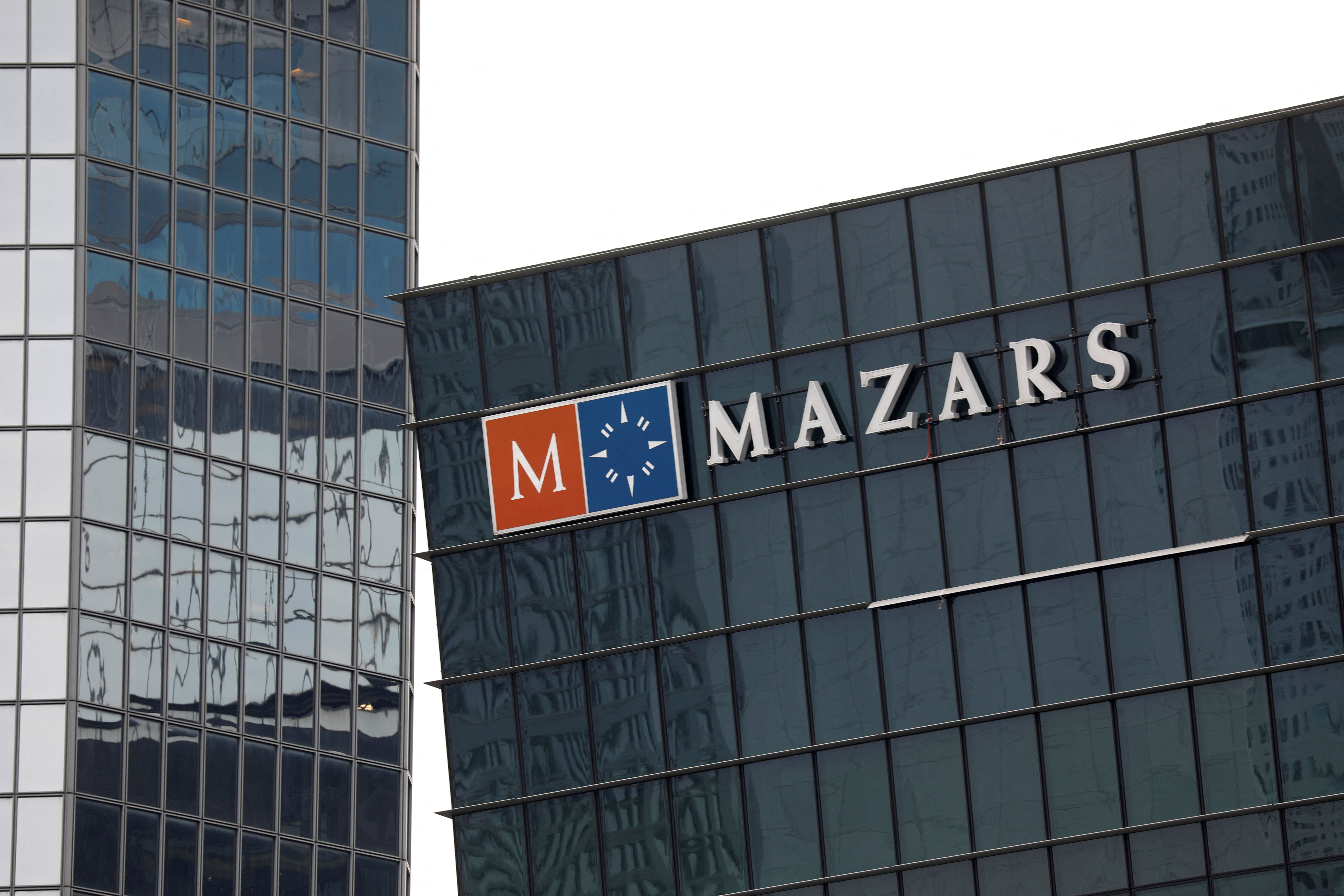 The logo of Mazars, an international, integrated organisation, that is specialised in audit, accounting, tax and advisory services is seen on a building in the financial district of la Defense near Paris