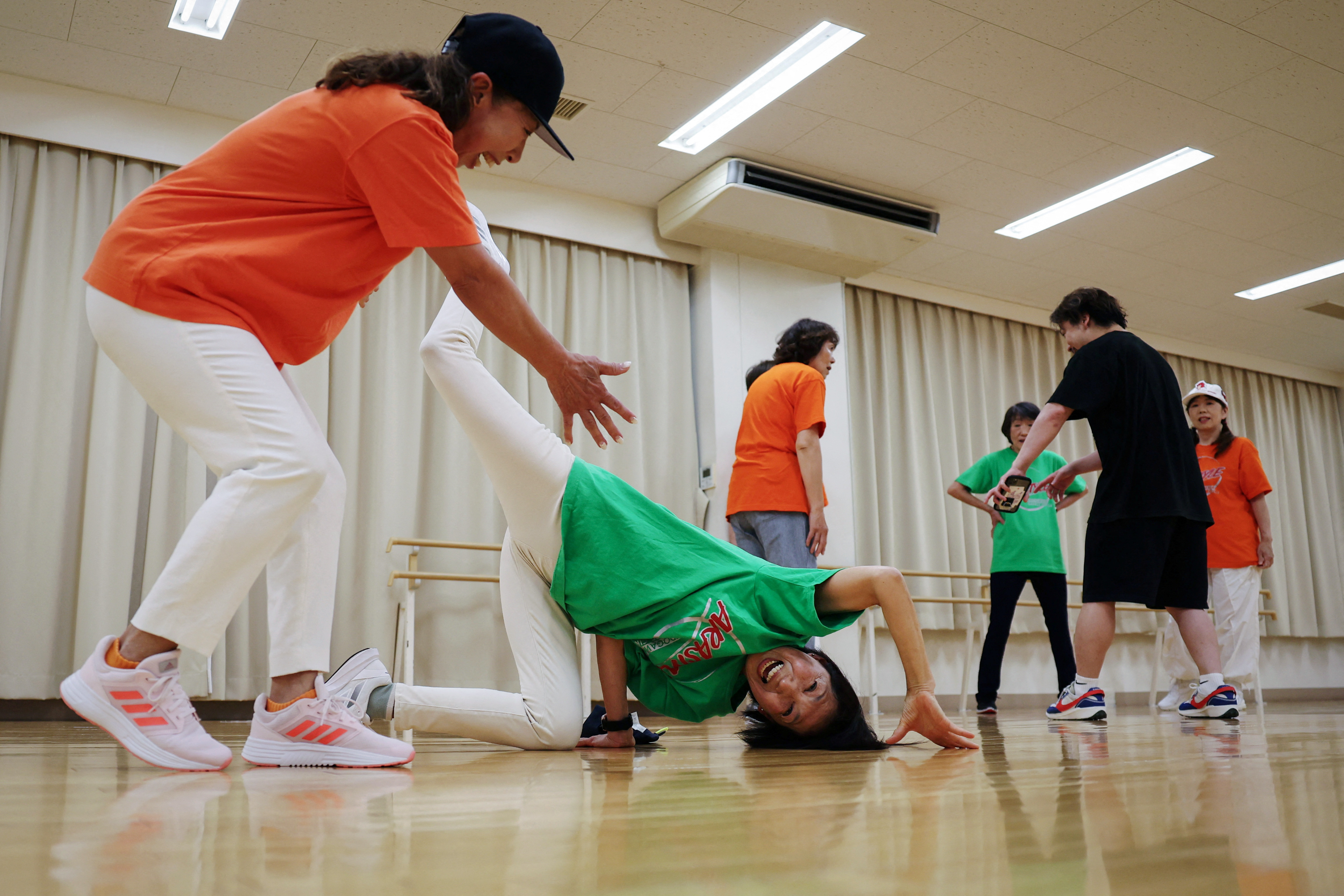 The Wider Image: Inspired by Olympics debut, Japan's seniors blaze breakdancing trail