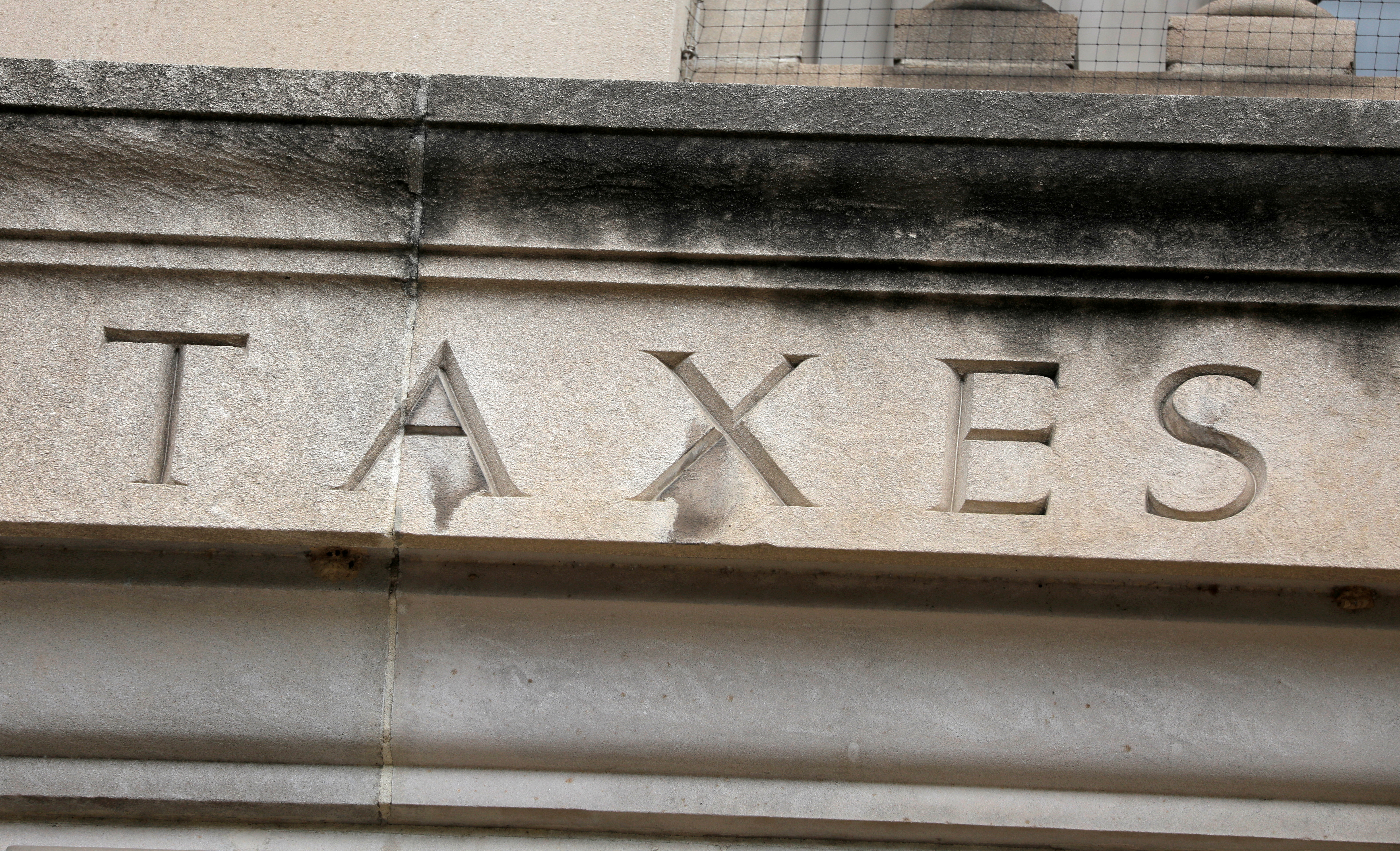 The word "taxes" is seen engraved at the headquarters of the Internal Revenue Service (IRS) in Washington, D.C.
