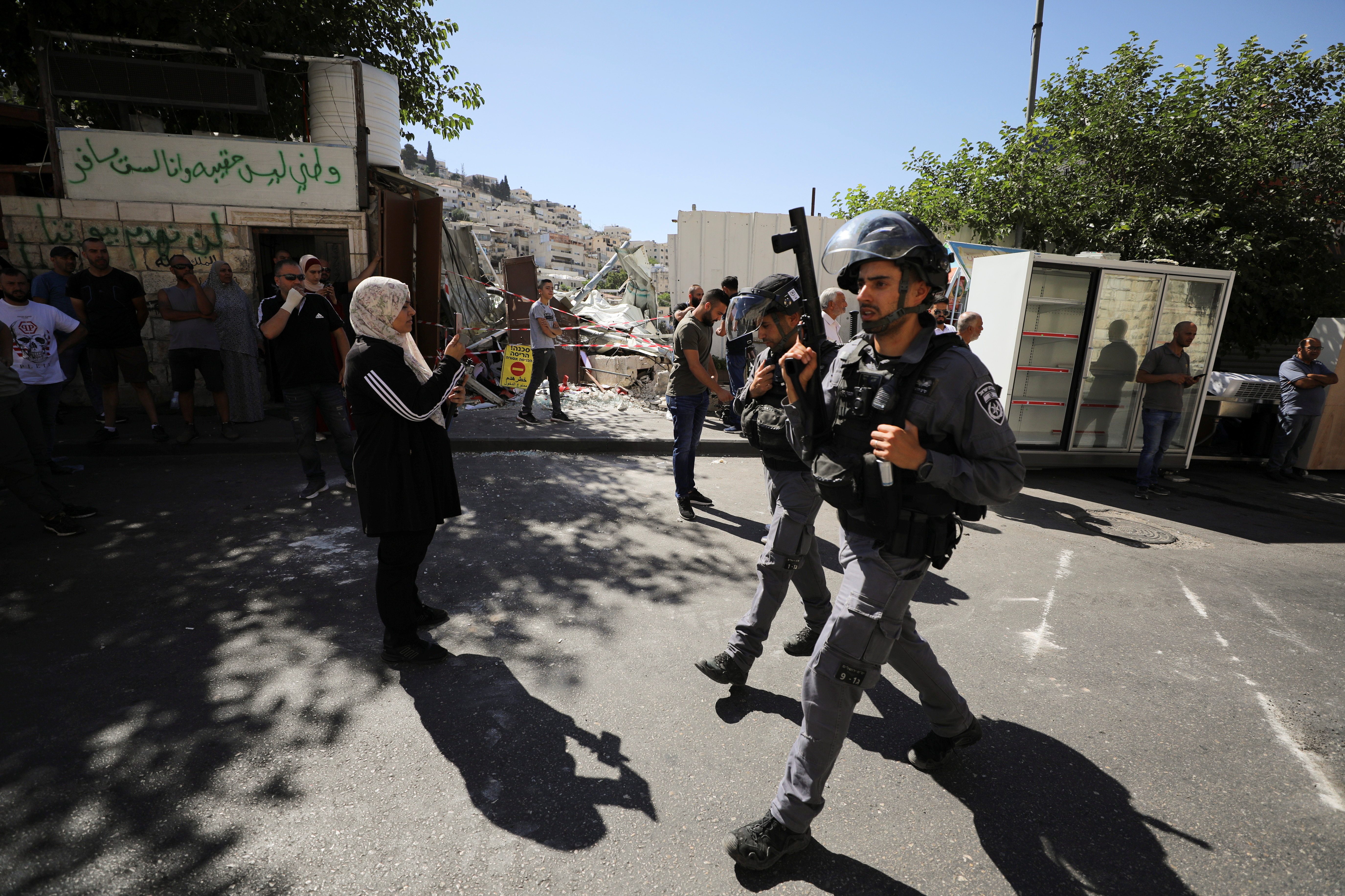 An Israeli security force member holds his weapon during clashes with Palestinians which erupted over Israel's demolition of a shop in the Palestinian neighbourhood of Silwan in East Jerusalem