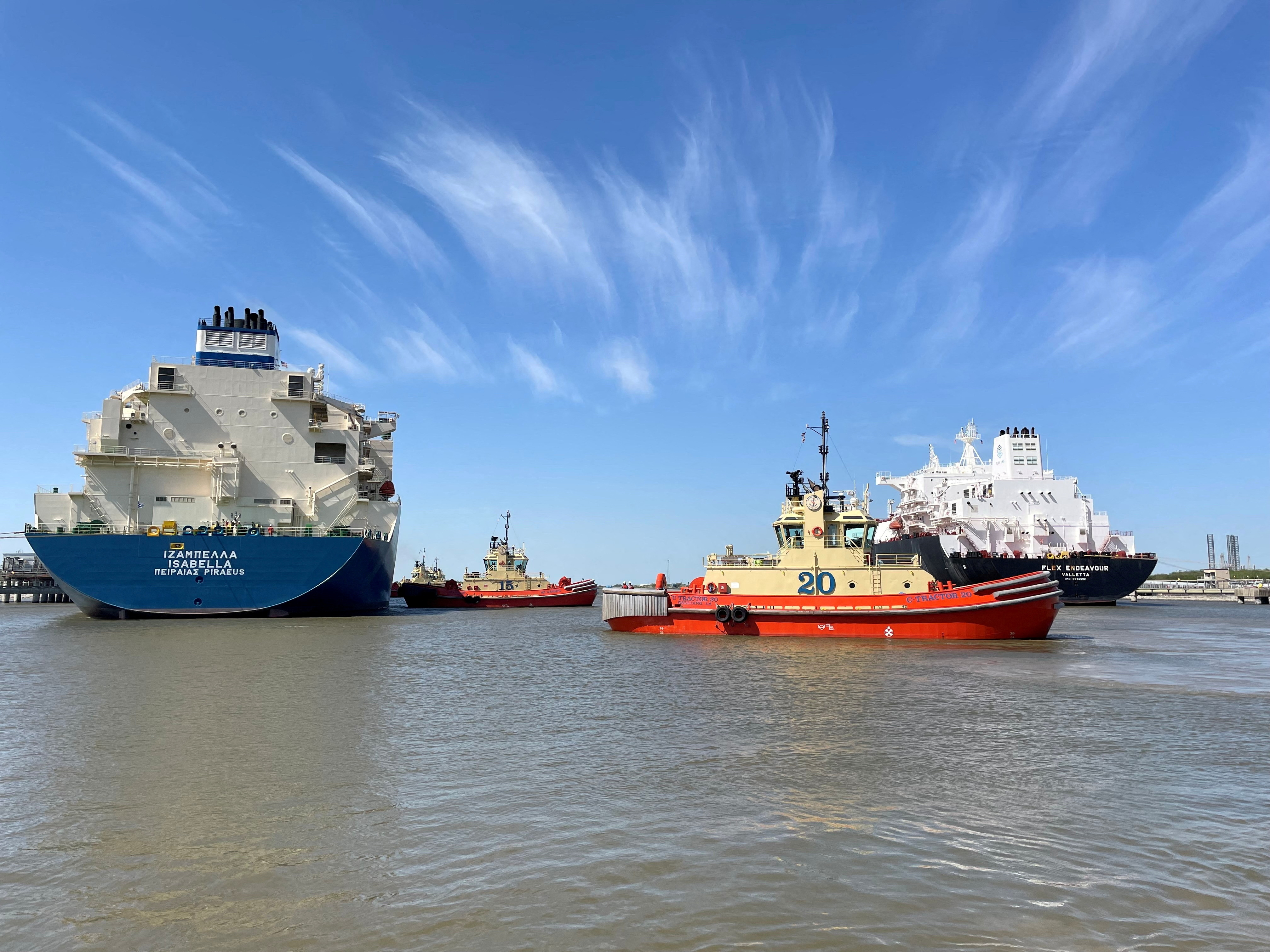 An LNG tanker is guided by tug boats at the Cheniere Sabine Pass LNG export unit in Cameron Parish, Louisiana