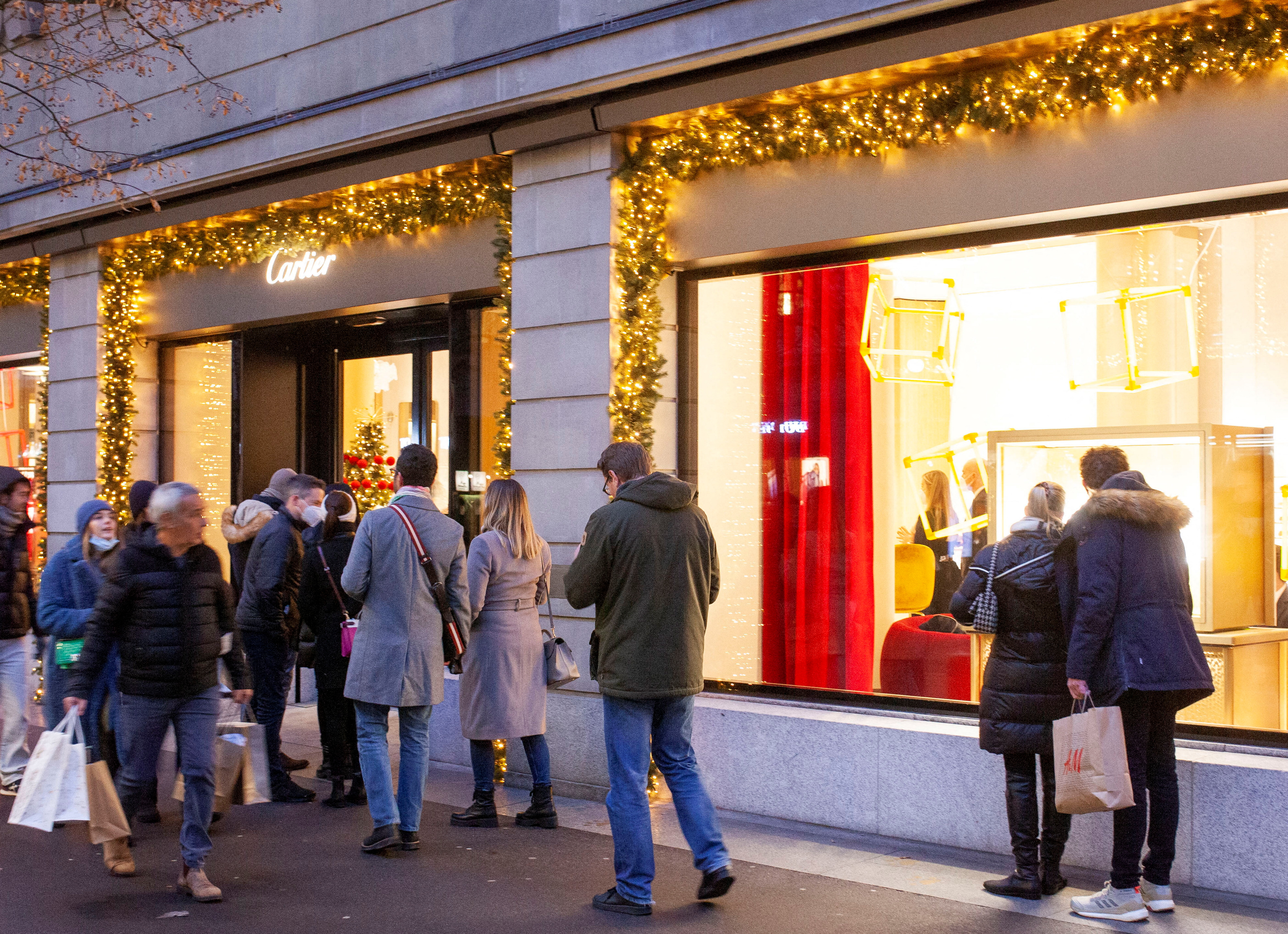 Shoppers are seen in front of a Cartier store in Zurich
