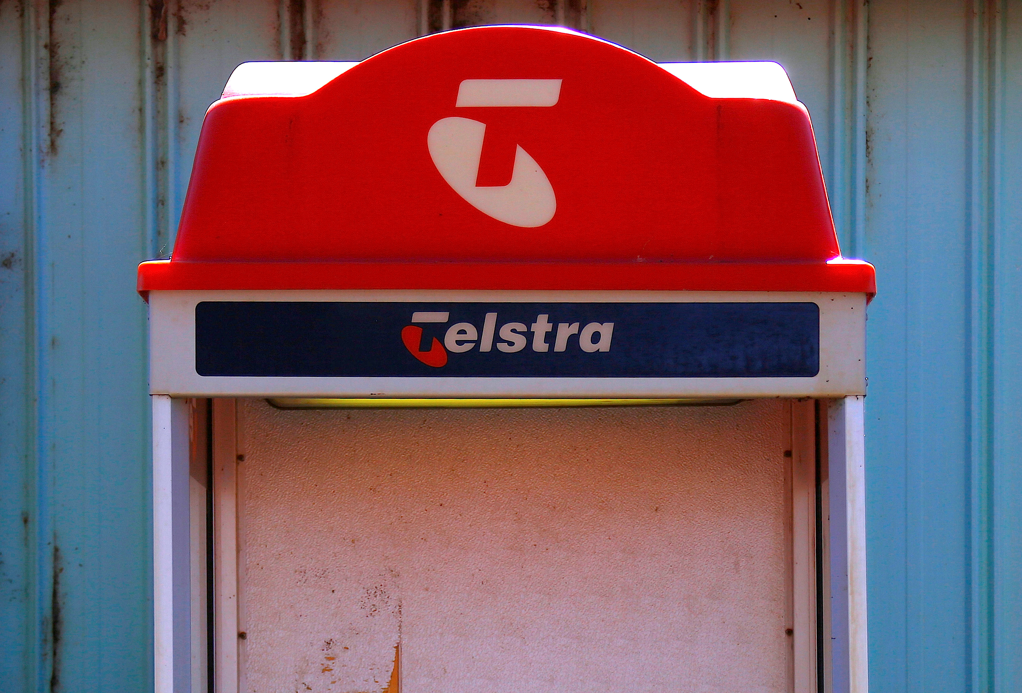 A public phone booth displaying the logo for Telstra Corp Ltd, Australia's biggest telecommunications company, stands outside the Cooladdi Post Office and motel, located in the town of Cooladdi in southwestern Queensland