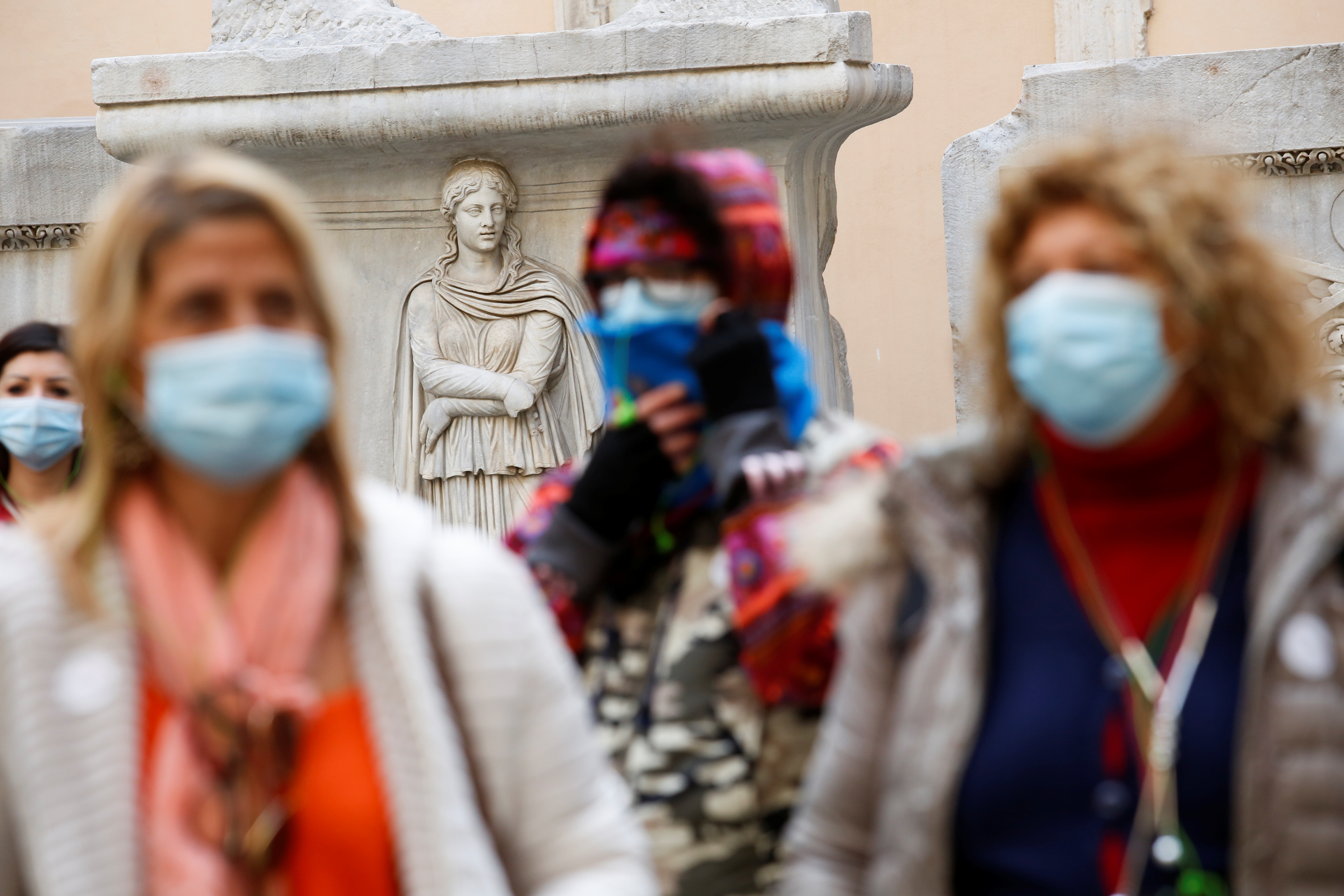 People wearing protective face masks walk at Capitoline Museums (Musei Capitolini), on the day before coronavirus disease (COVID-19) health passes, known as Green Passes, become mandatory on public transport, in Rome, Italy December 5, 2021. REUTERS/Remo Casilli