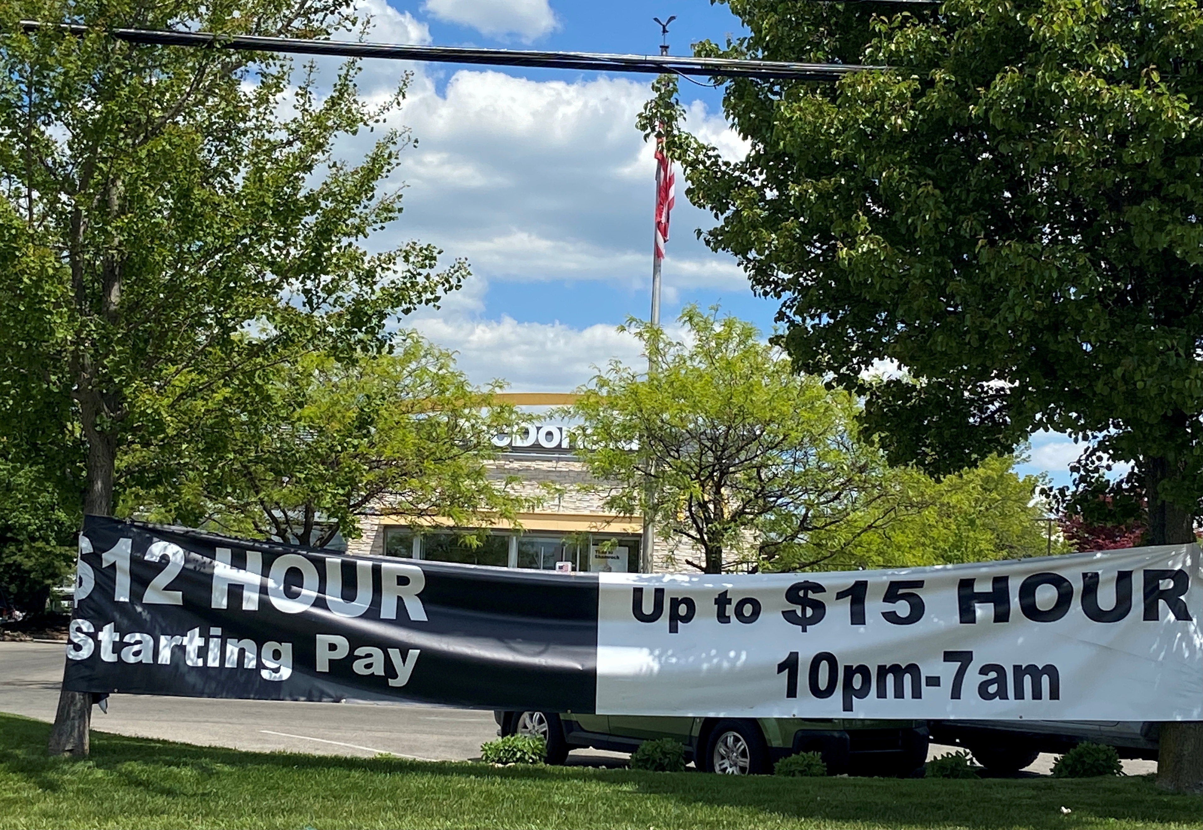 A banner inviting people to apply for open jobs is seen outside a McDonald's restaurant in Bloomington