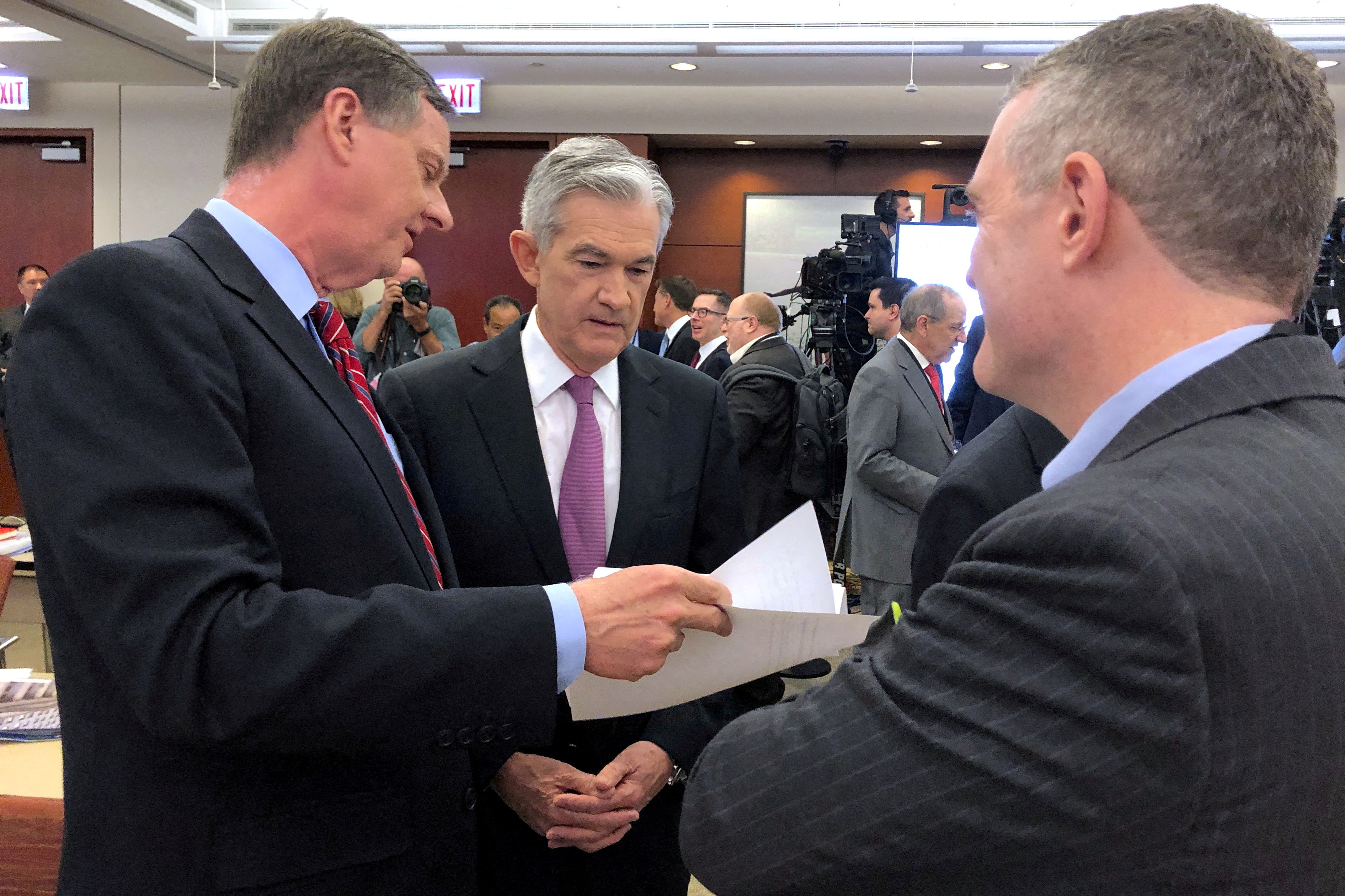 Federal Reserve Chair Jerome Powell speaks with Chicago Fed President Charles Evans and St. Louis Fed President James Bullard at a conference on monetary policy at the Federal Reserve Bank of Chicago