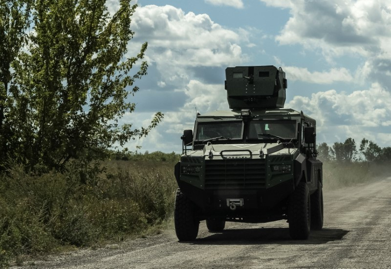 Ukrainian servicemen ride a military vehicle near the Russian border in Sumy region