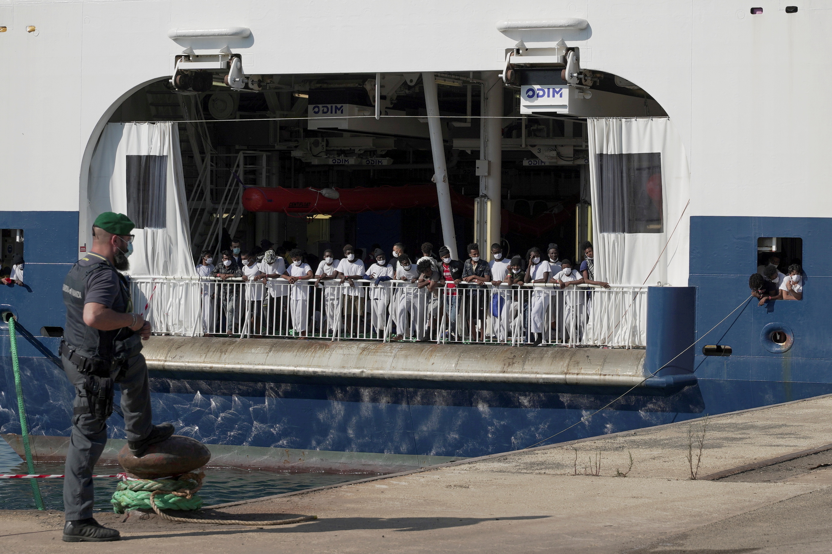 Migrants wait to disembark the ship 'Geo Barents' run by Doctors Without Borders (MSF) as it is given permission to dock at the Sicilian port of Augusta after a week of waiting at sea, in Augusta, Italy, June 18, 2021. REUTERS/Antonio Parrinello/File Photo