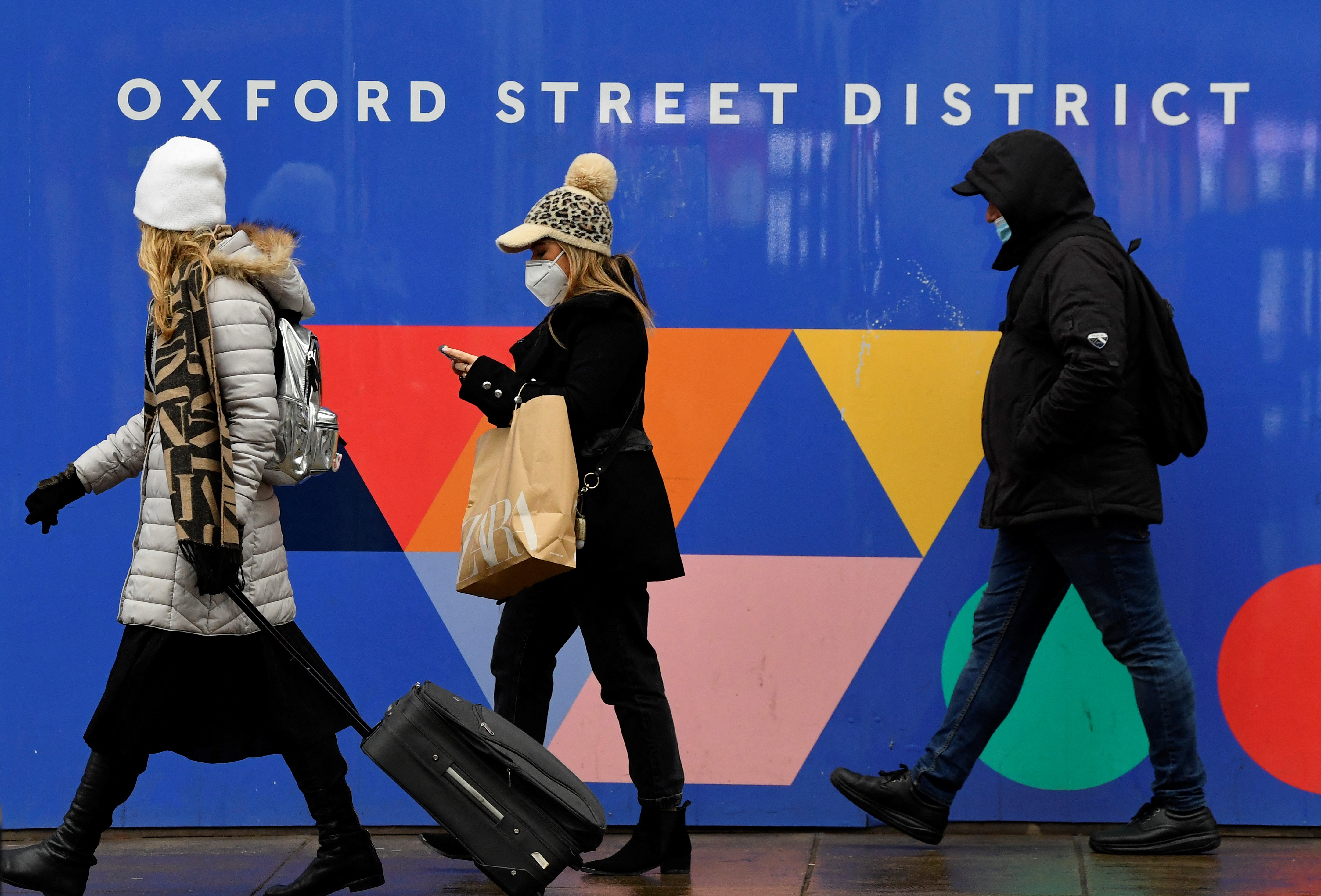 Shoppers walk on Oxford Street as rules on wearing face coverings in some settings in England are relaxed, amid the spread of the coronavirus disease (COVID-19) pandemic, in London