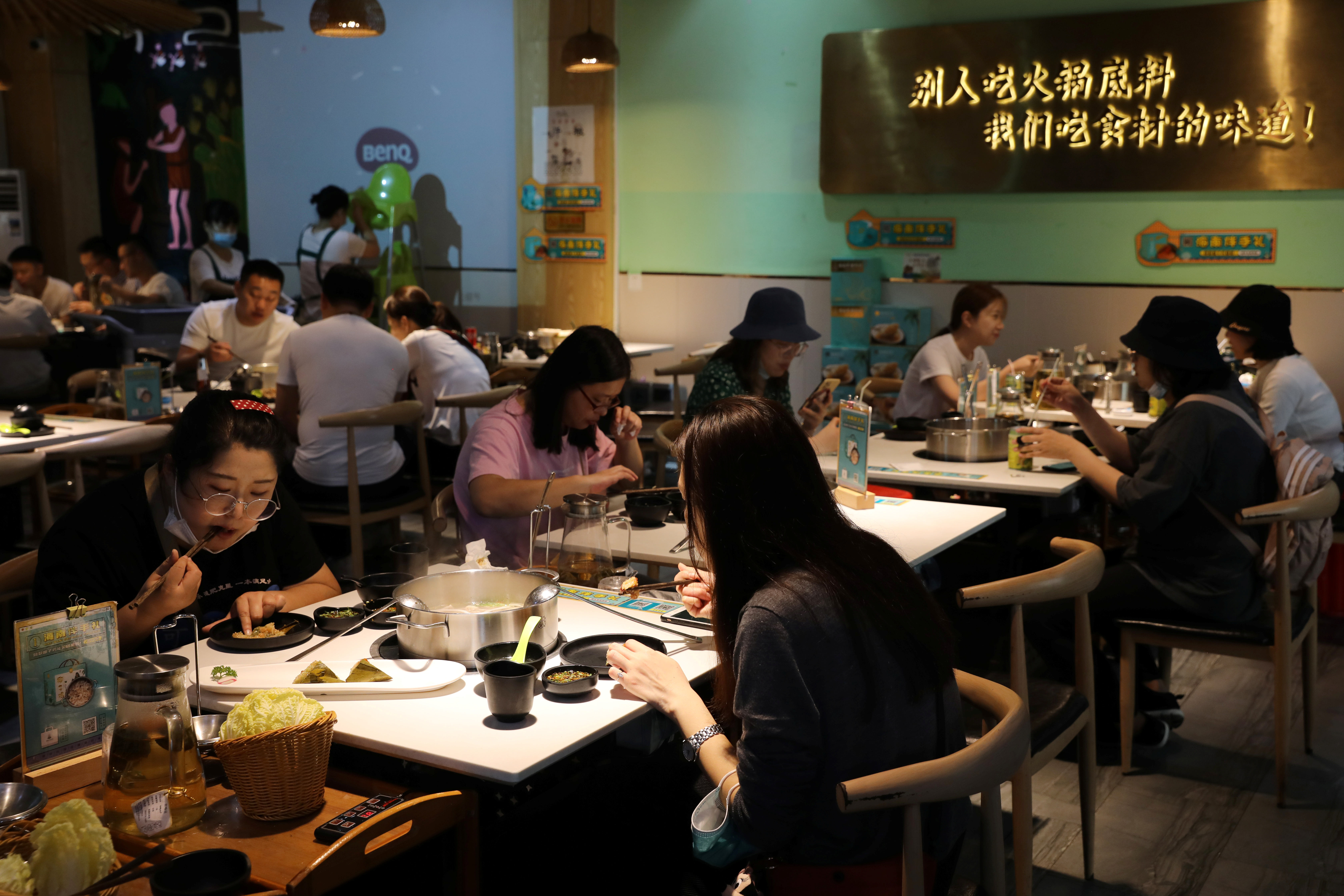 People dine at a hotpot restaurant in Sanya