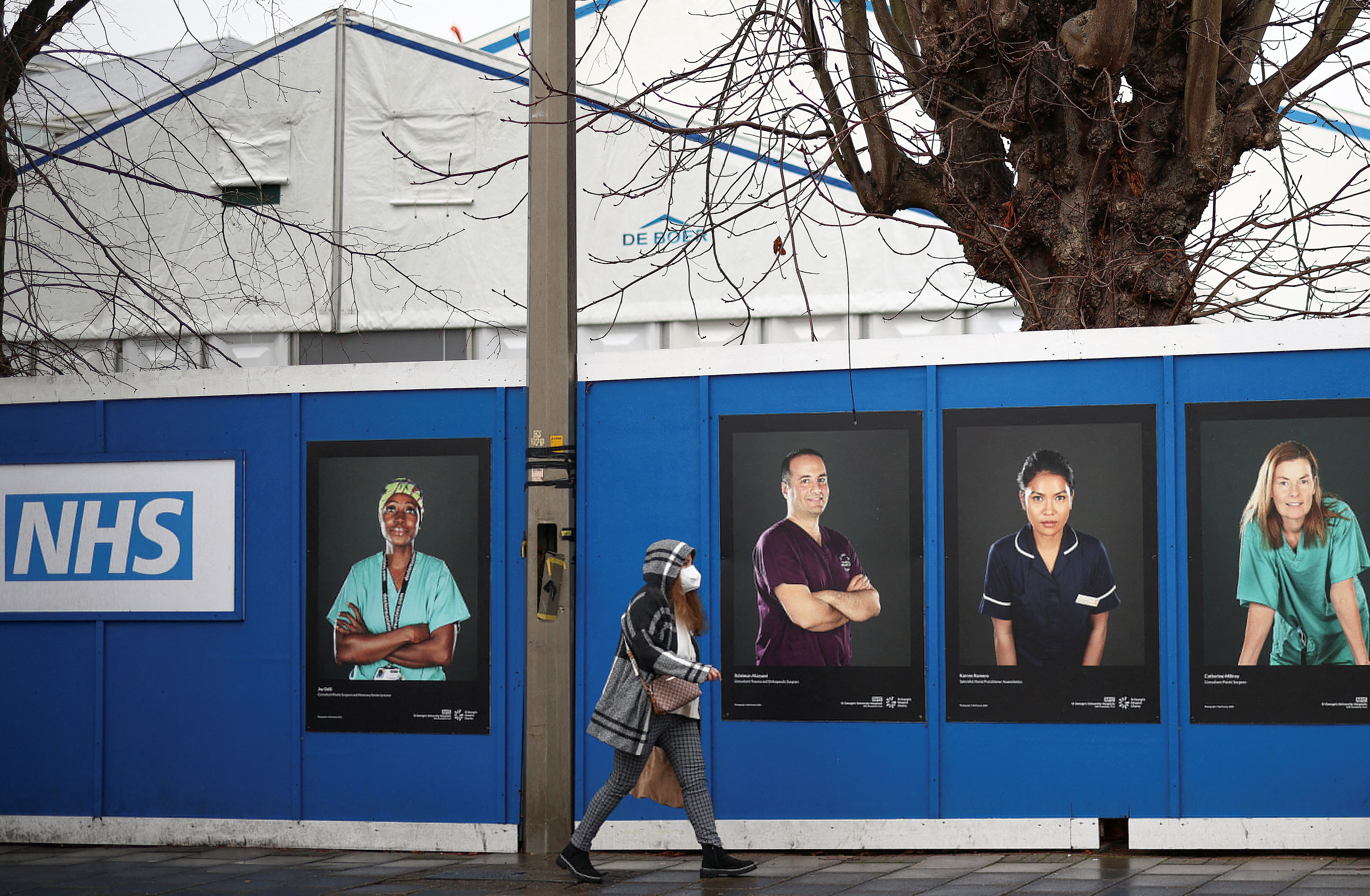 Images of National Health Service (NHS) workers displayed on hoardings outside a temporary field hospital at St George's Hospital in London