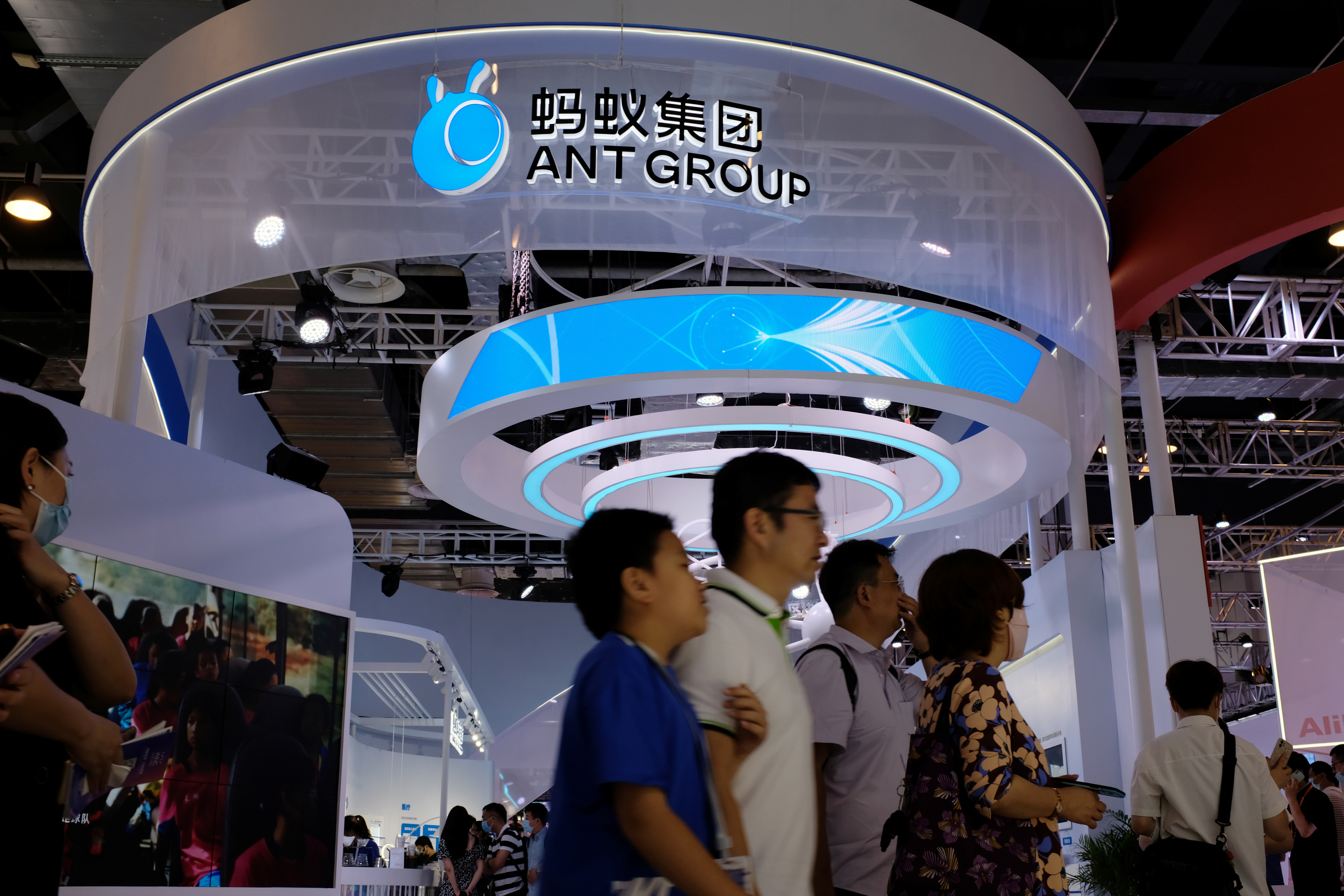 People walk past the Ant Group booth in Shanghai