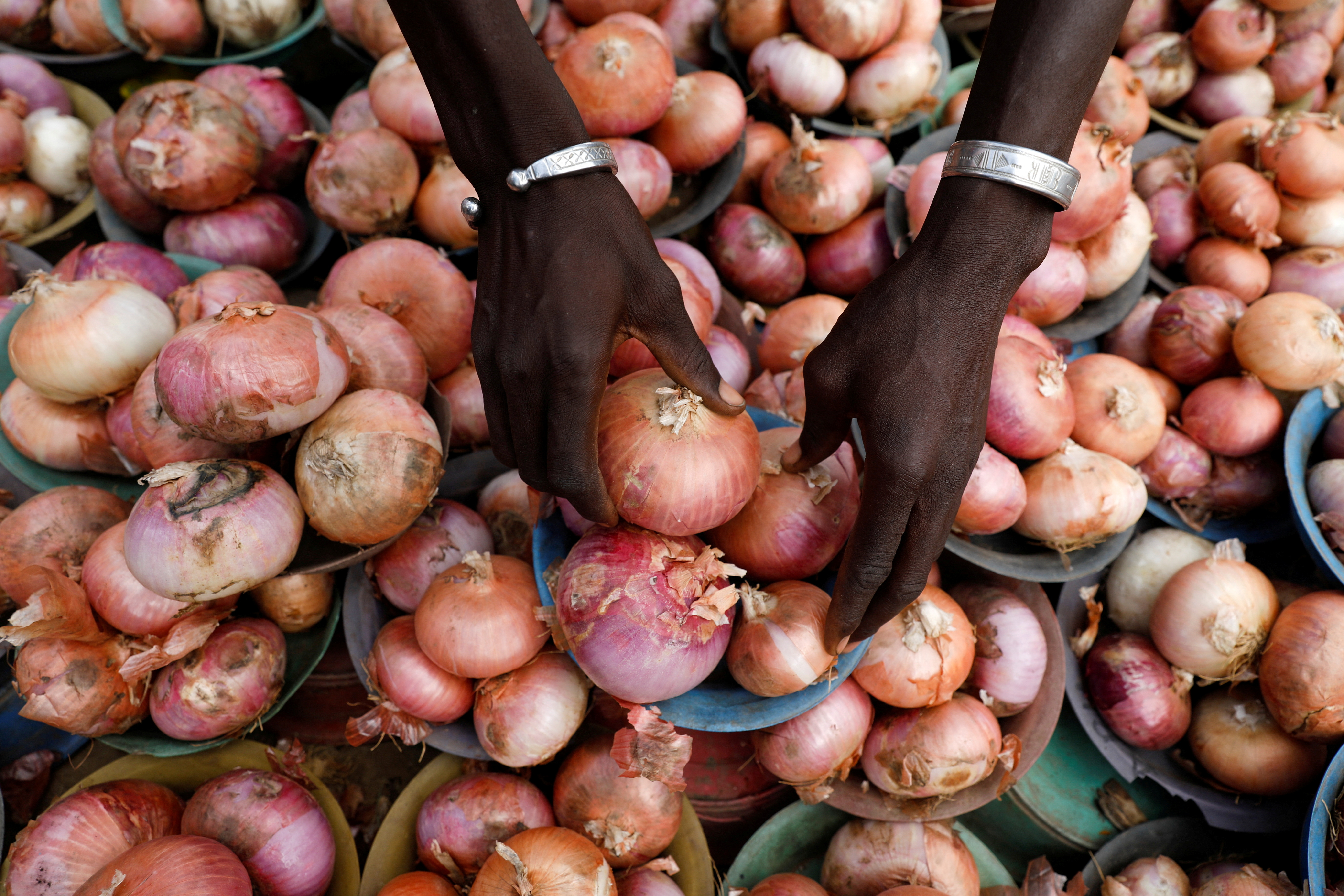 A vendor arranges onions for sale at Mile 12 International Market in Lagos