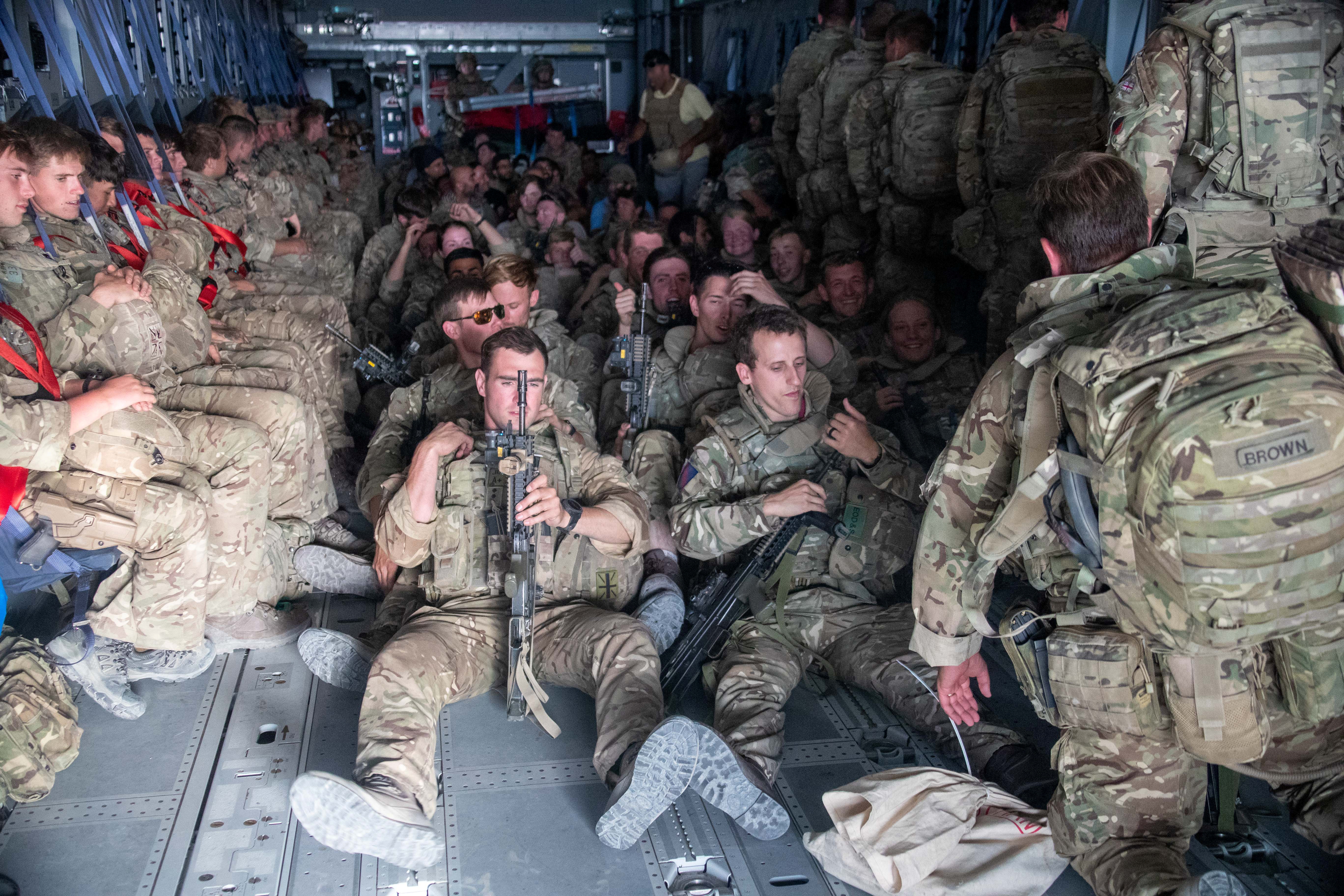 UK military personnel are seen onboard an A400M aircraft departing Kabul