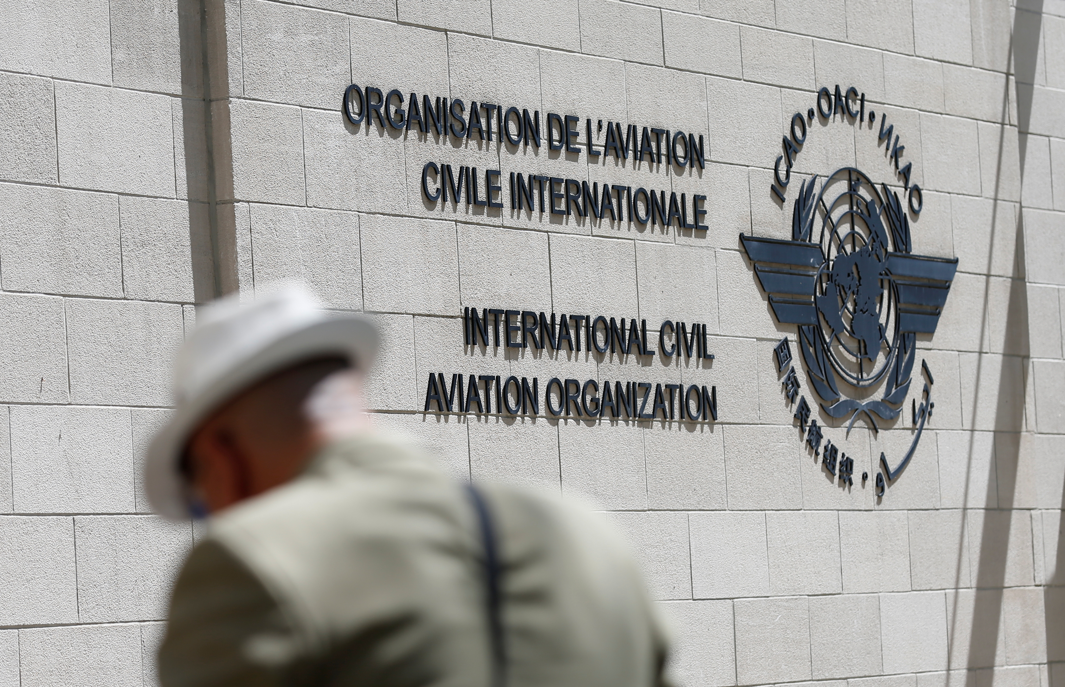 A man eats lunch outside the International Civil Aviation Organization (ICAO) headquarters building in Montreal