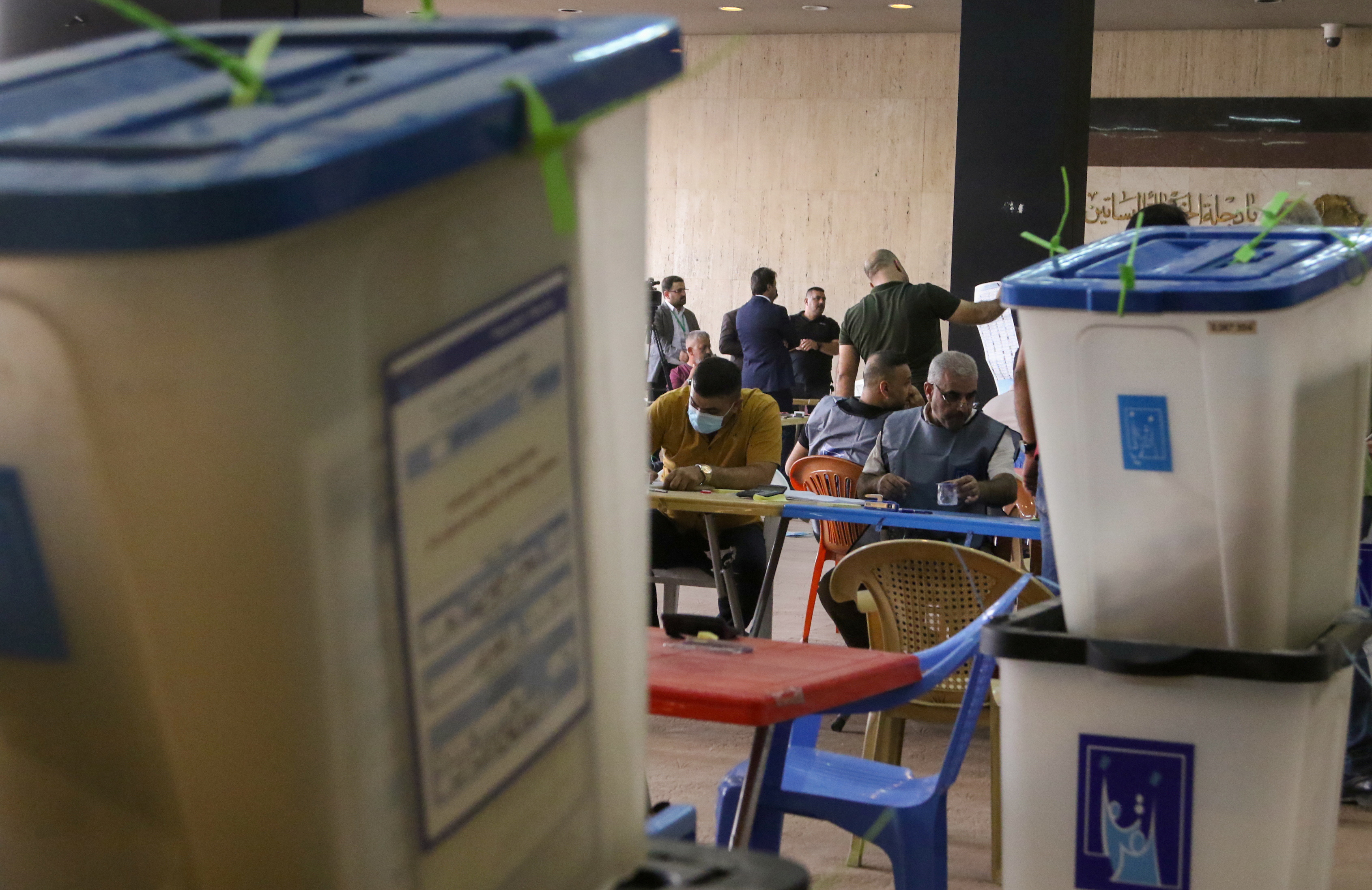 Employees of Iraq's Independent High Electoral Commission count votes at the Green Zone in Baghdad, Iraq, October 13, 2021. REUTERS/Ahmed Saad