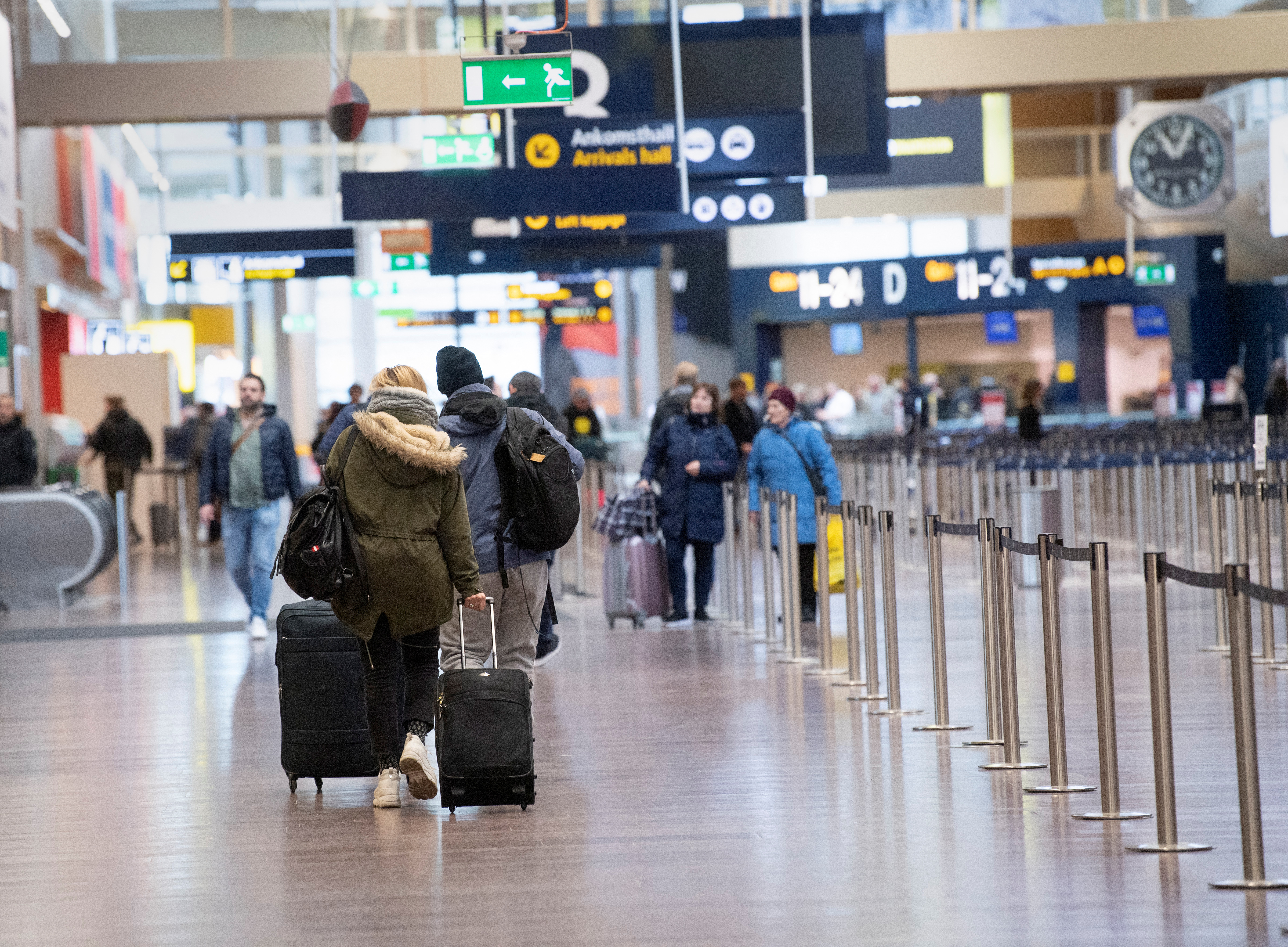 Travelers walk at Arlanda International Airport following the coronavirus concern and cancelled flights in Stockholm