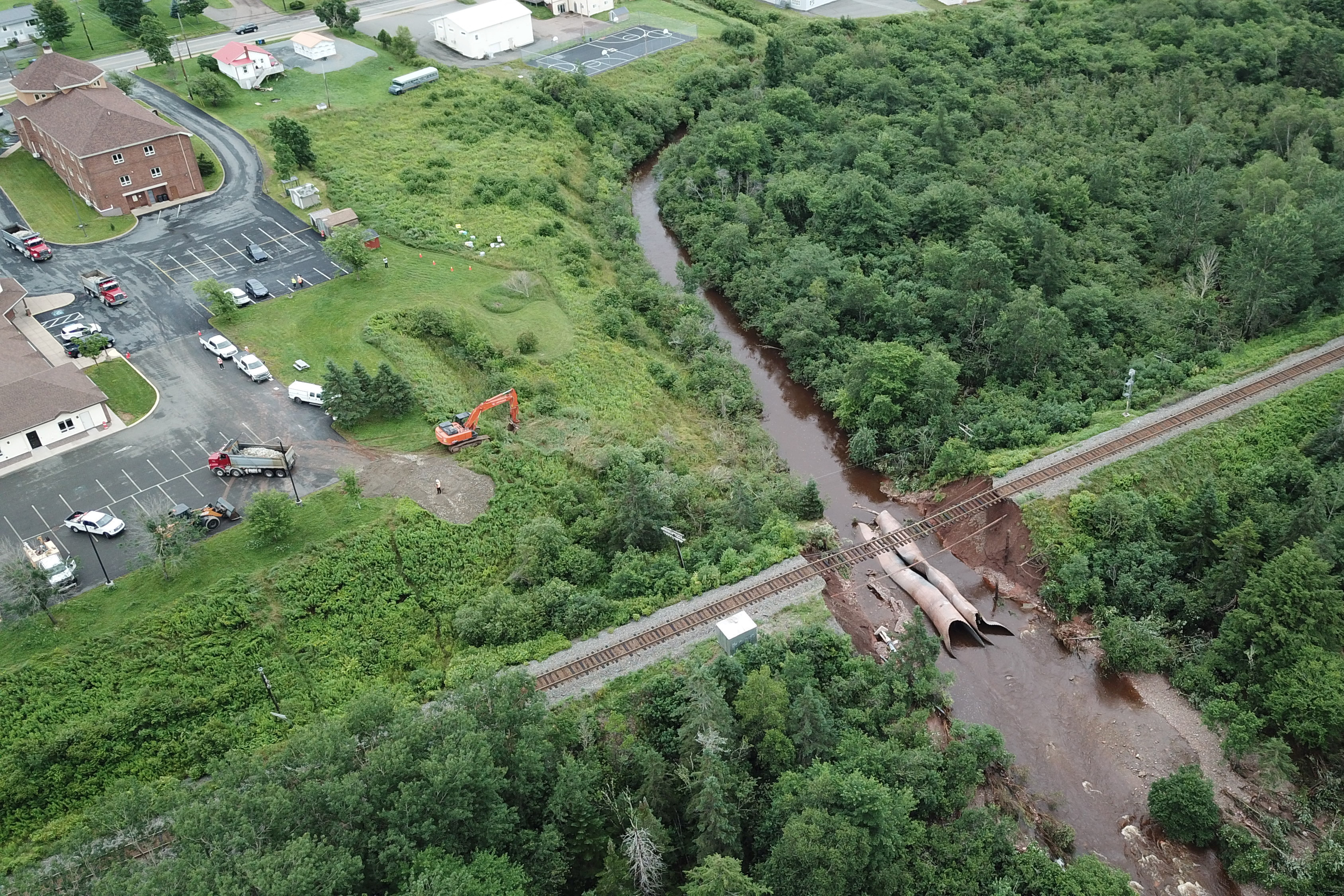 Water flows through a washed-out culvert on the main CN Rail line in Truro