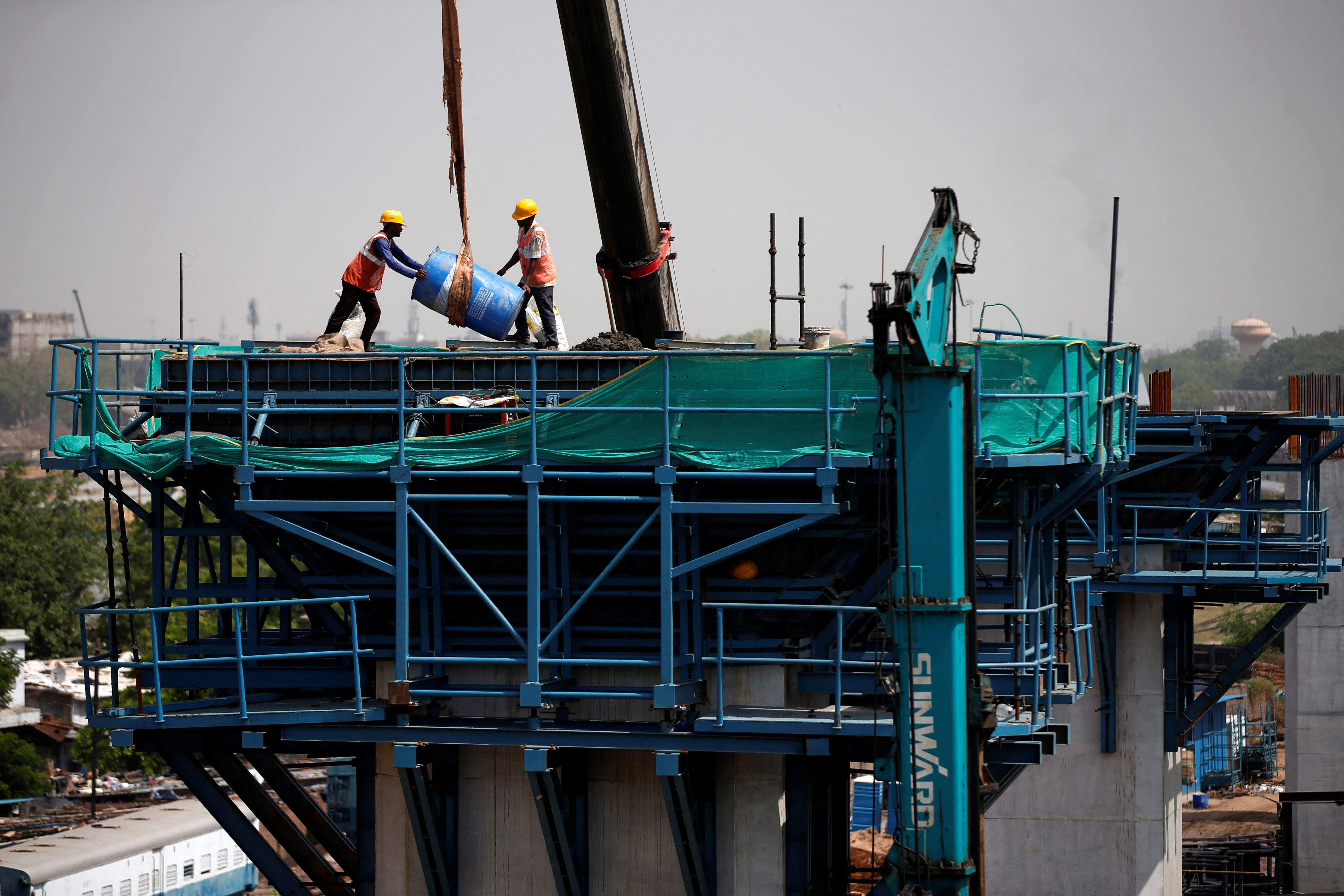Labourers work at a construction site of the Ahmedabad-Mumbai High Speed Rail corridor in Ahmedabad