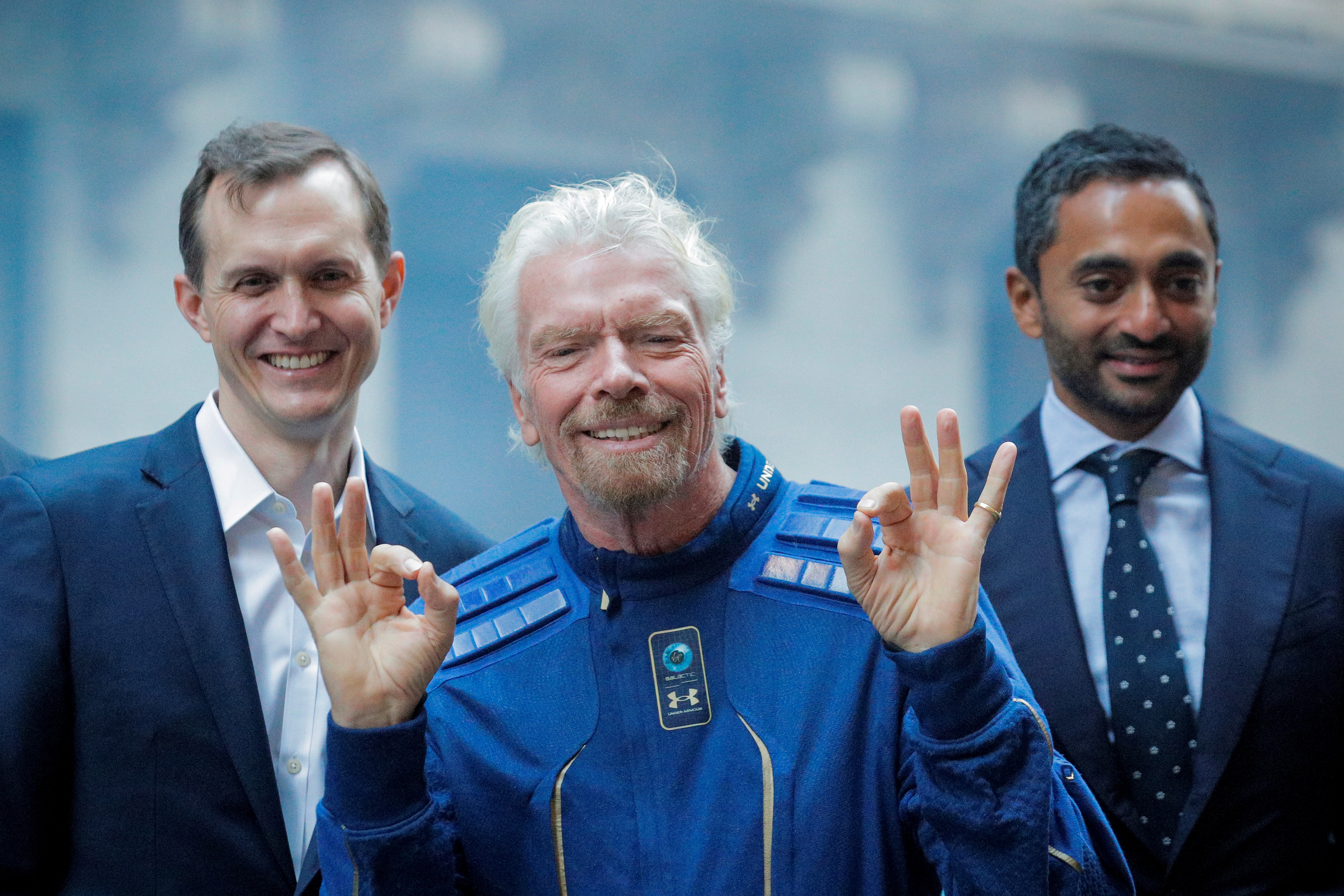 Virgin Galactic co-founder Sir Richard Branson, CEO George Whitesides and Social Capital CEO Chamath Palihapitiya pose together outside of the New York Stock Exchange n New York, U.S., October 28, 2019. REUTERS/Brendan McDermid/File Photo