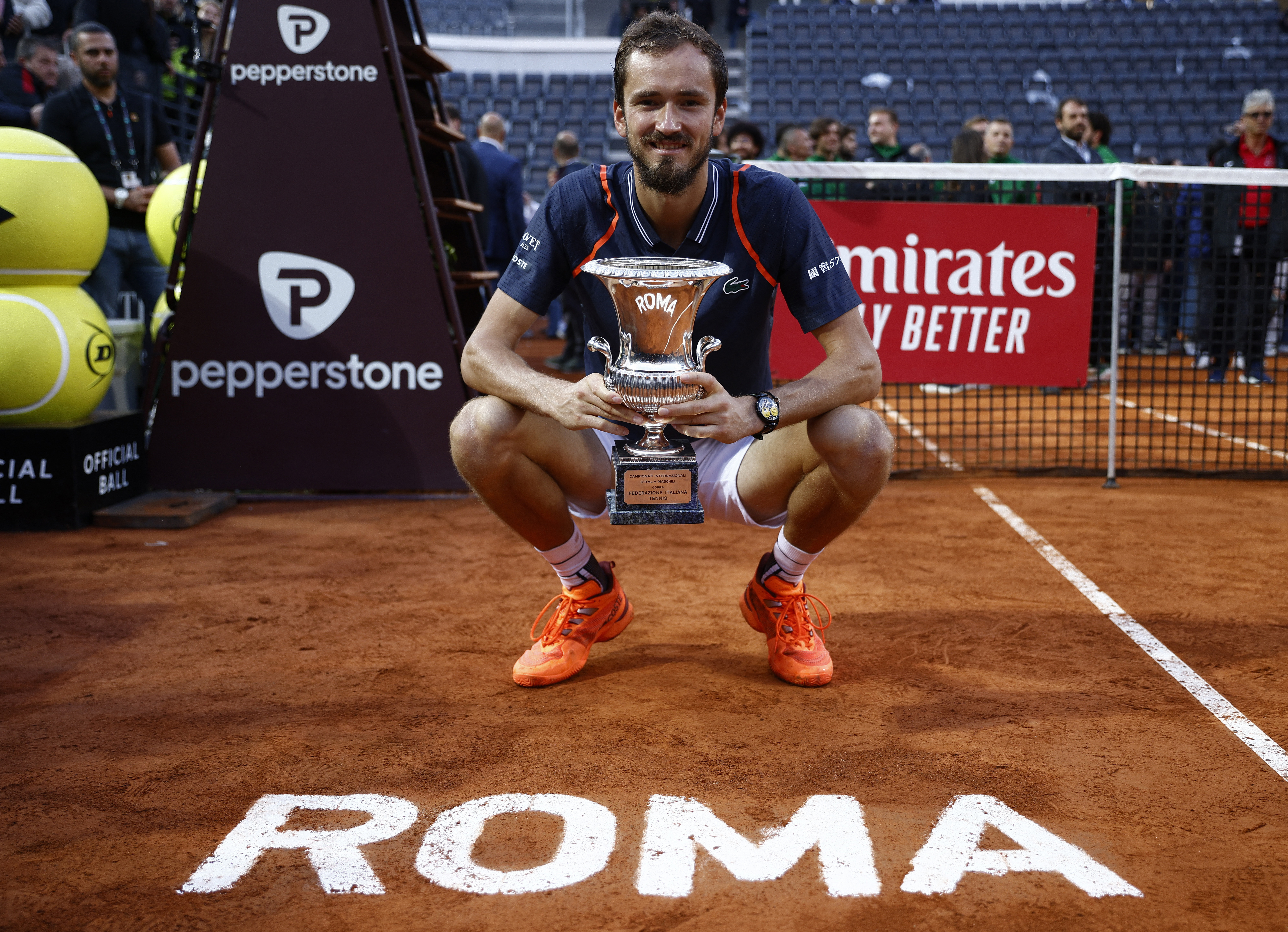 Daniil Medvedev of Russia, right, poses after winning the final