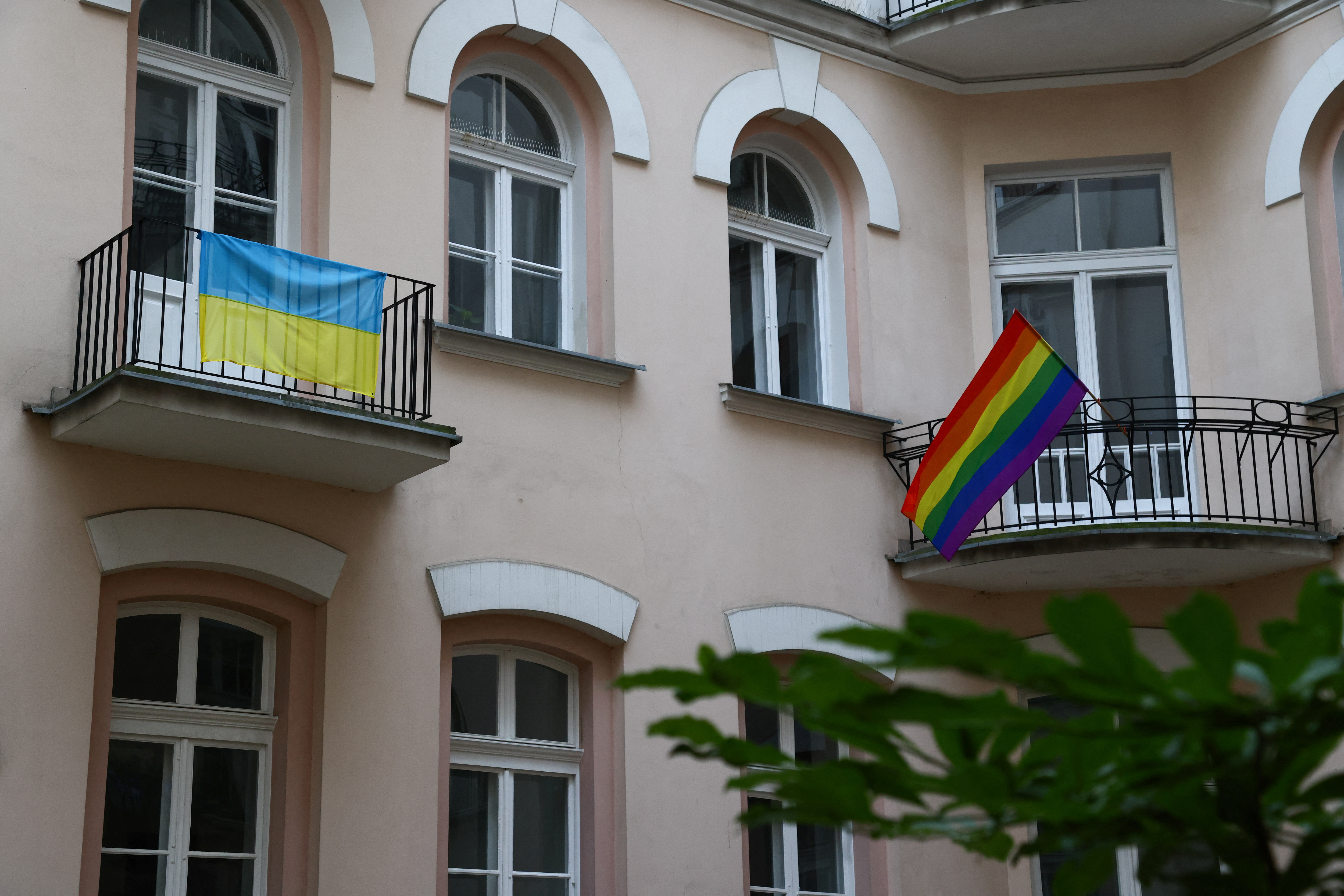 The Ukrainian flag and LGBT+ Rainbow flag are pictured on the balcony of the Campaign Against Homophobia office in Warsaw