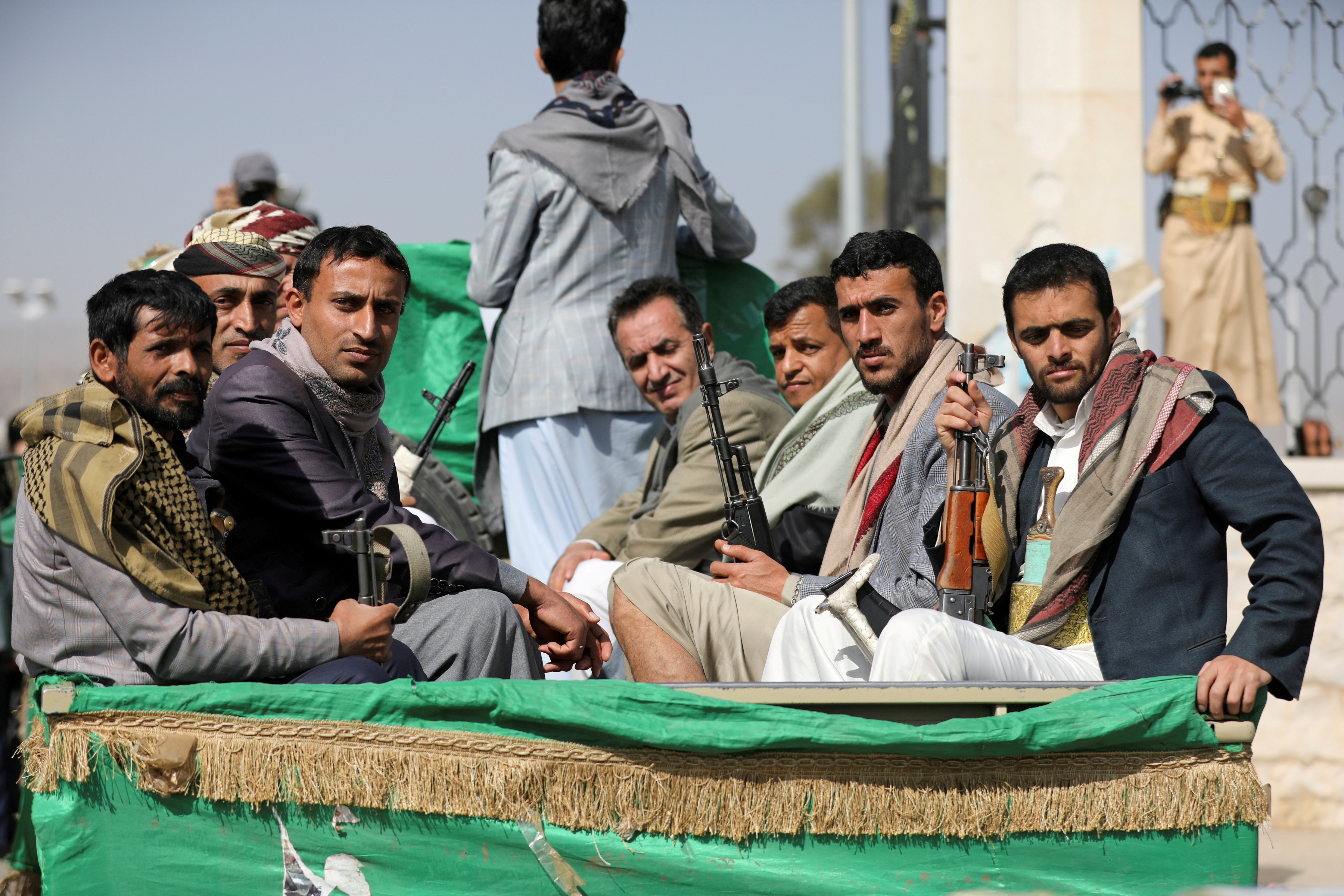 Armed Houthi followers ride on the back of a truck after participating in a funeral of Houthi fighters killed in recent fighting against government forces in Yemen's oil-rich province of Marib, in Sanaa, Yemen