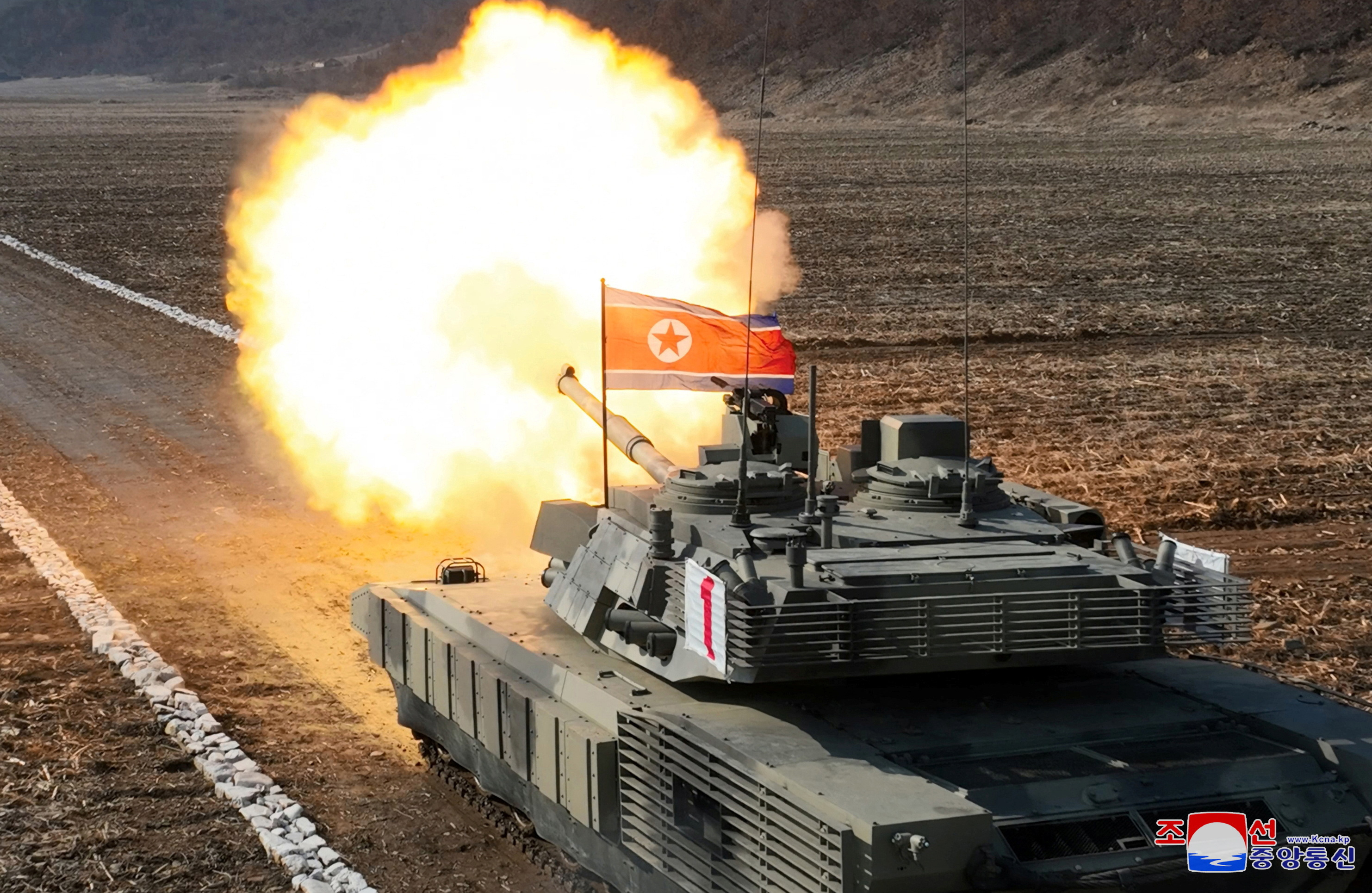 North Korea's Kim drives newly developed battle tank during launch