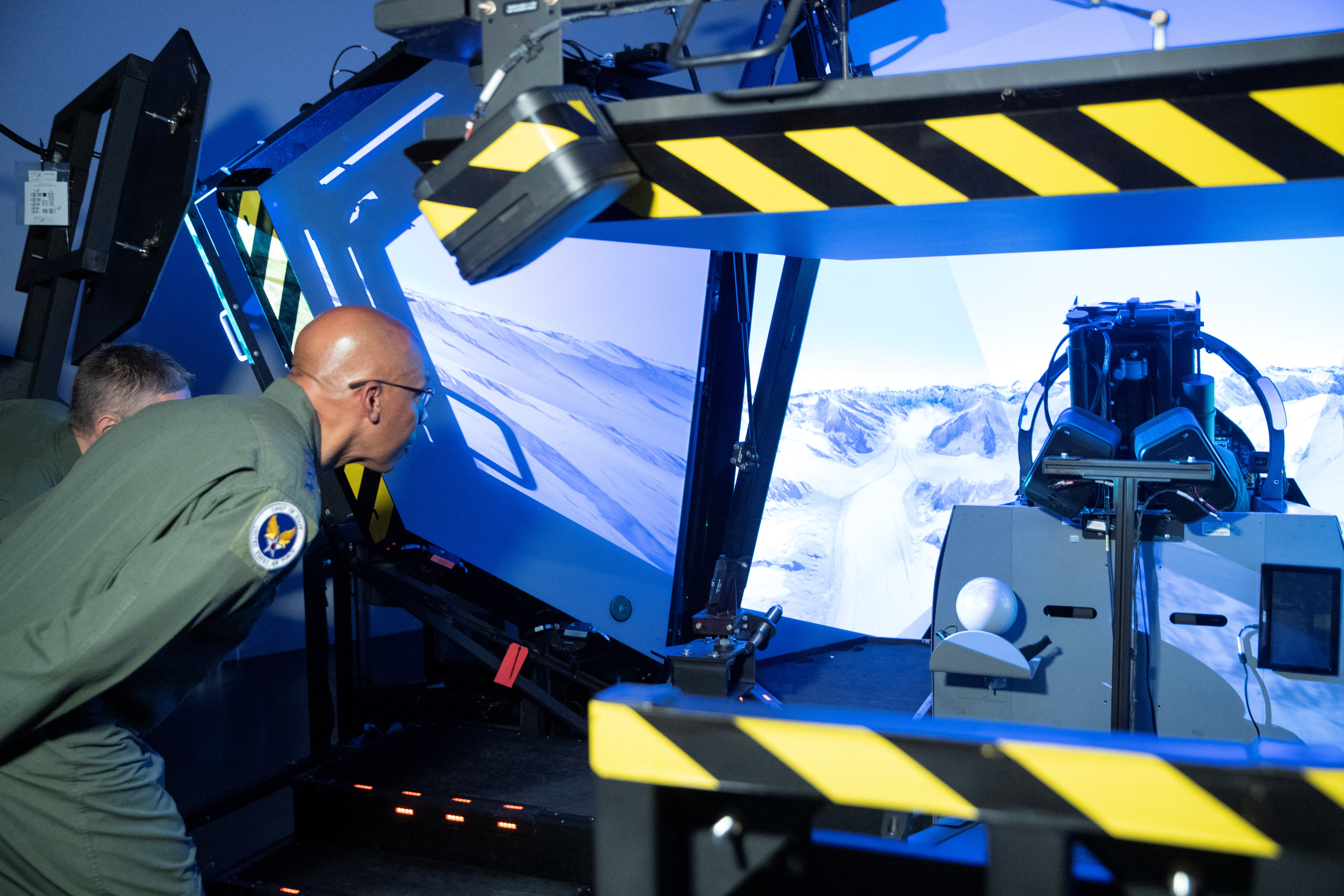 Chief of Staff of the U.S. Air Force General Brown Jr. looks into a flight simulator in Payerne