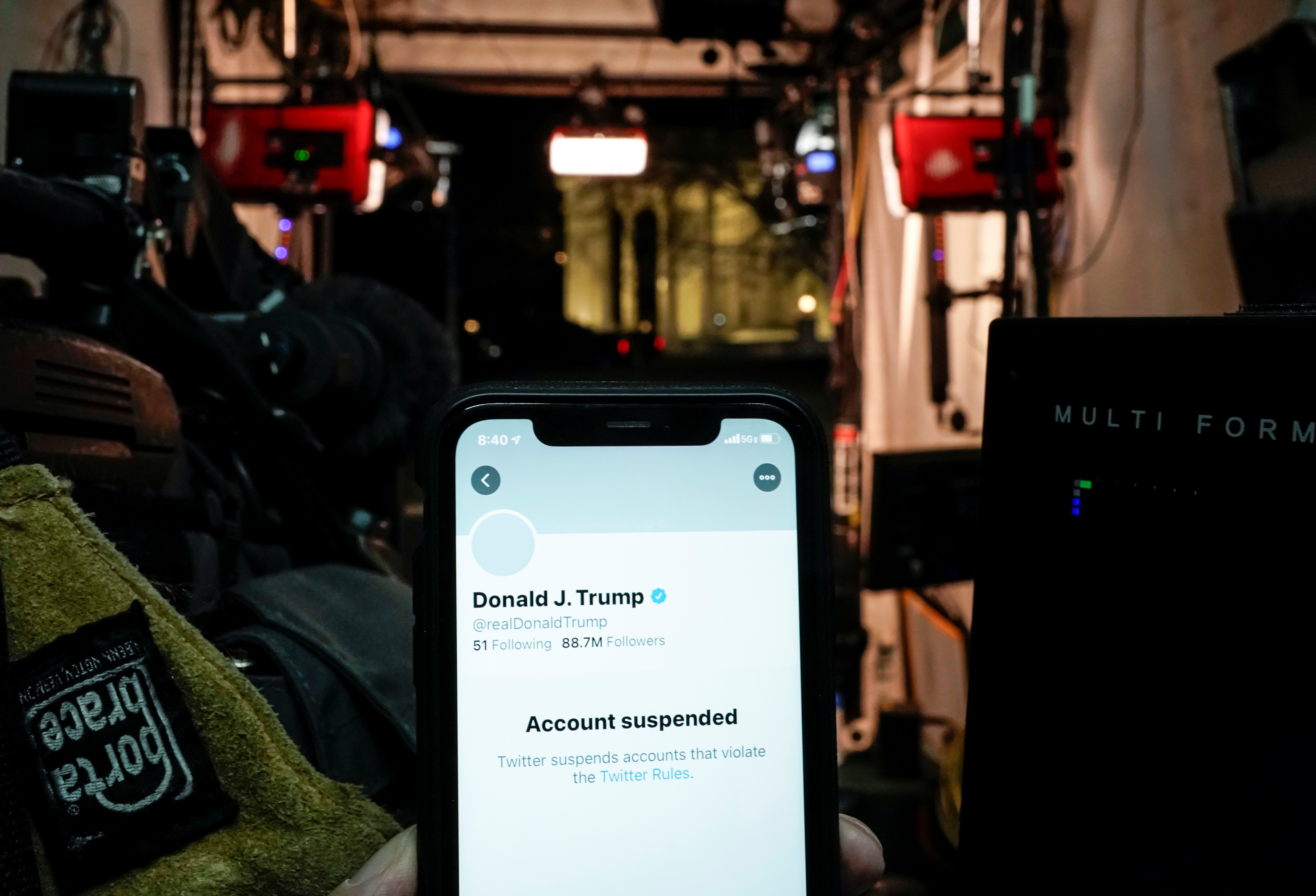 A photo illustration shows the suspended Twitter account of U.S. President Donald Trump on a smartphone in a media board cast tent at the White House in Washington