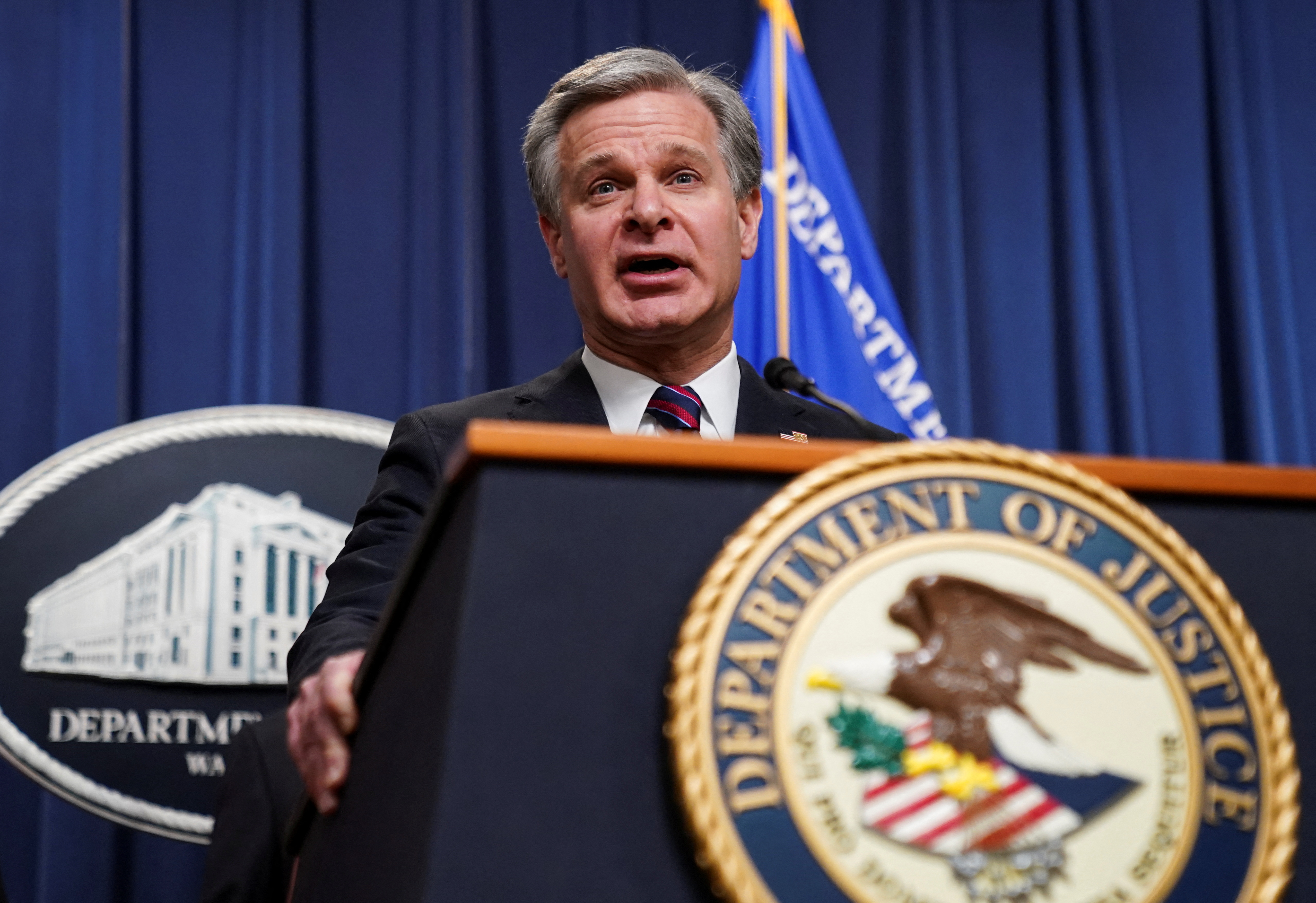 FBI Director Wray discusses charges against transnational crime group at the Justice Department in Washington