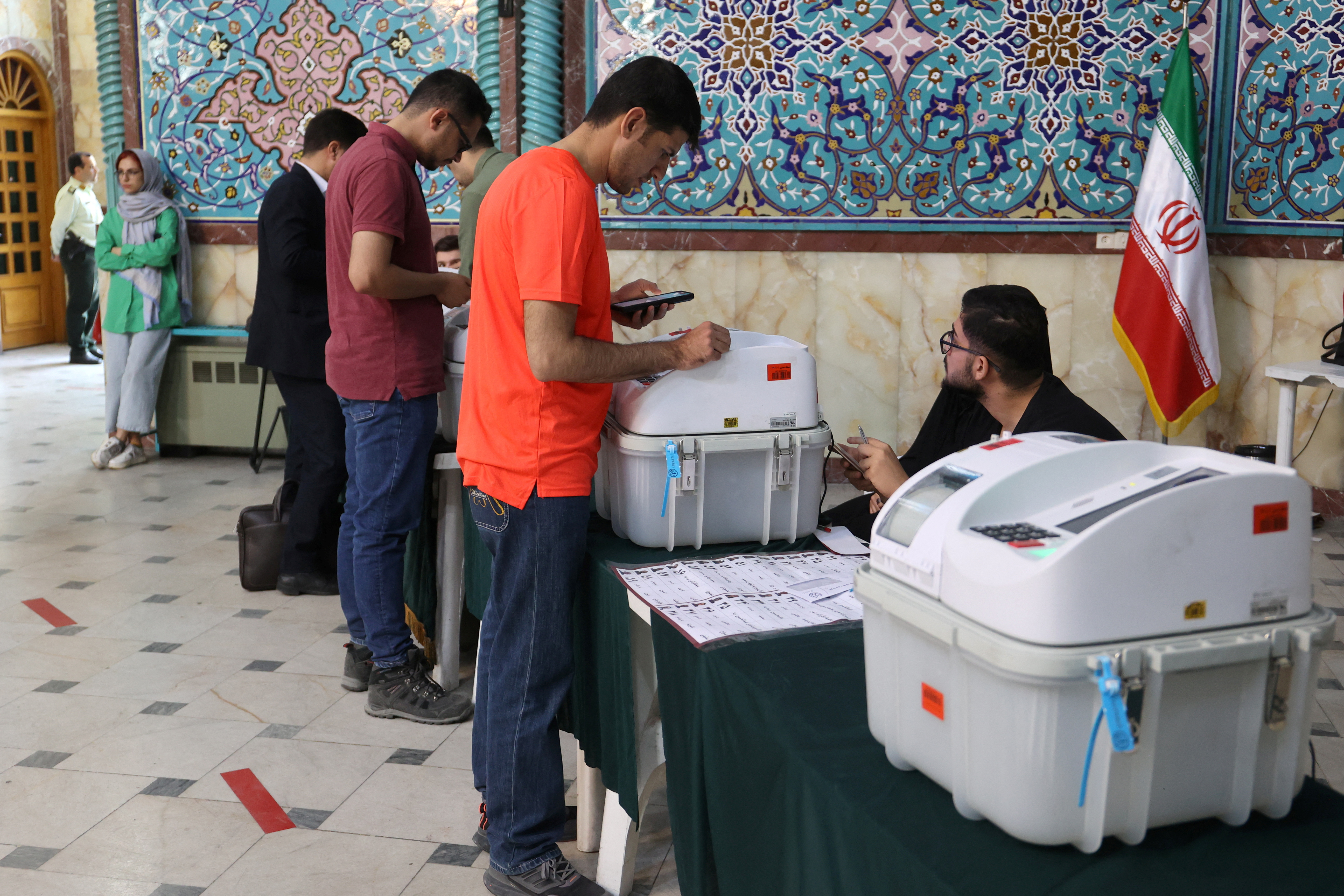 People vote during the runoff parliamentary elections in Tehran