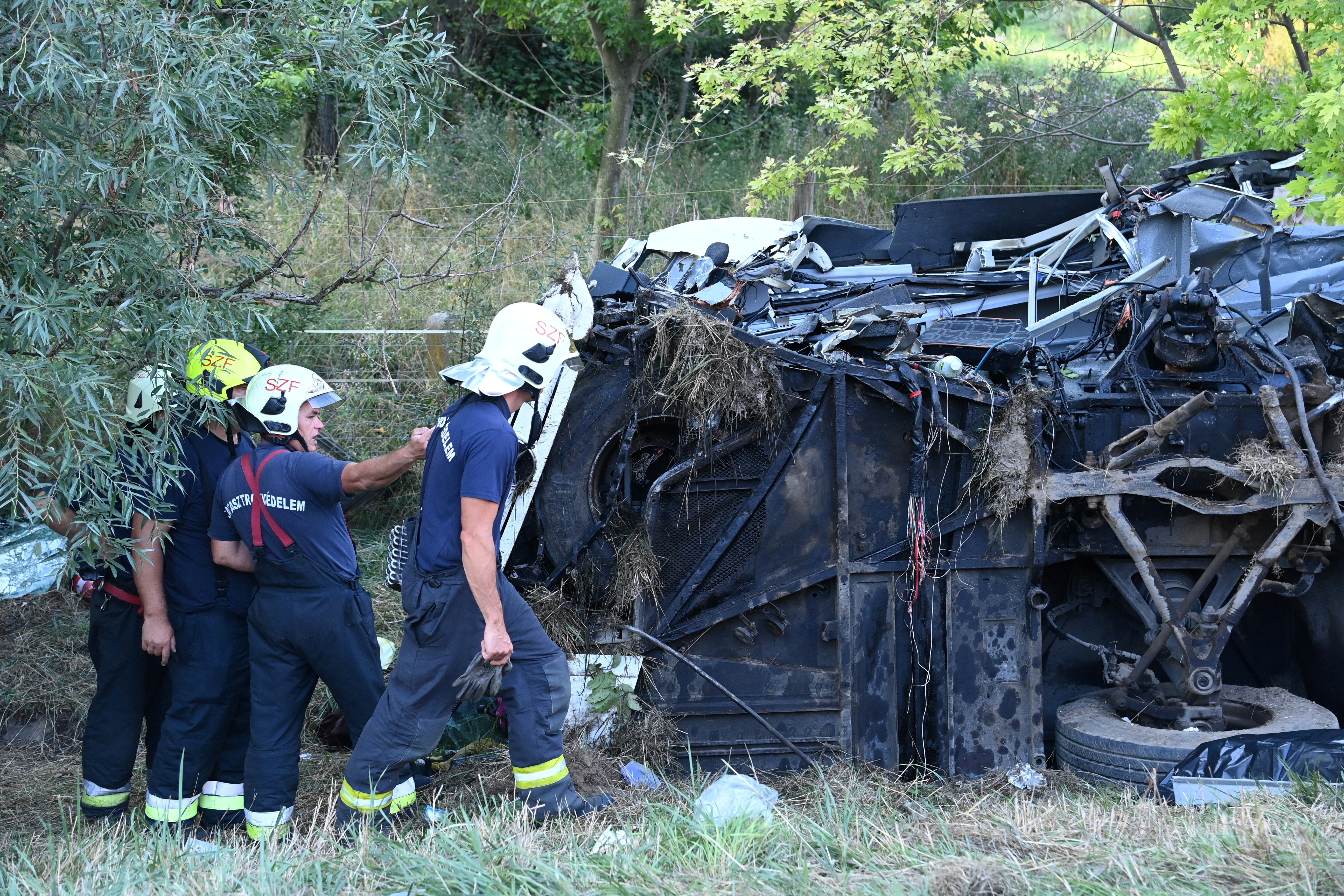 First responders work at the crash site, after a bus rolled over on the M7 motorway, killing at least eight people, in the early hours of Sunday near Szabadbattyan, Hungary August 15, 2021. Zoltan Mihadak/Pool via REUTERS