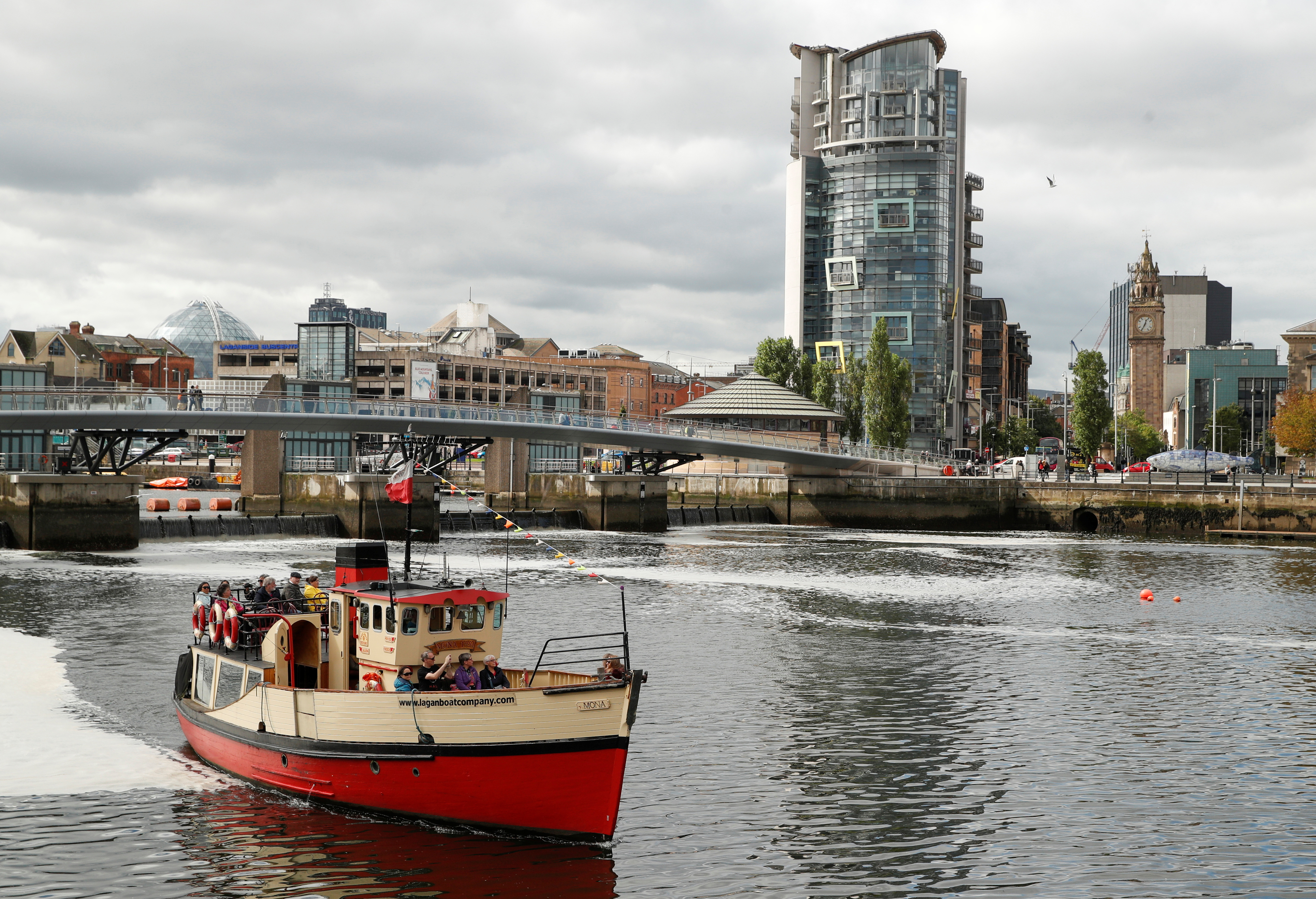 A tourist boat is seen on the river Lagan in Belfast