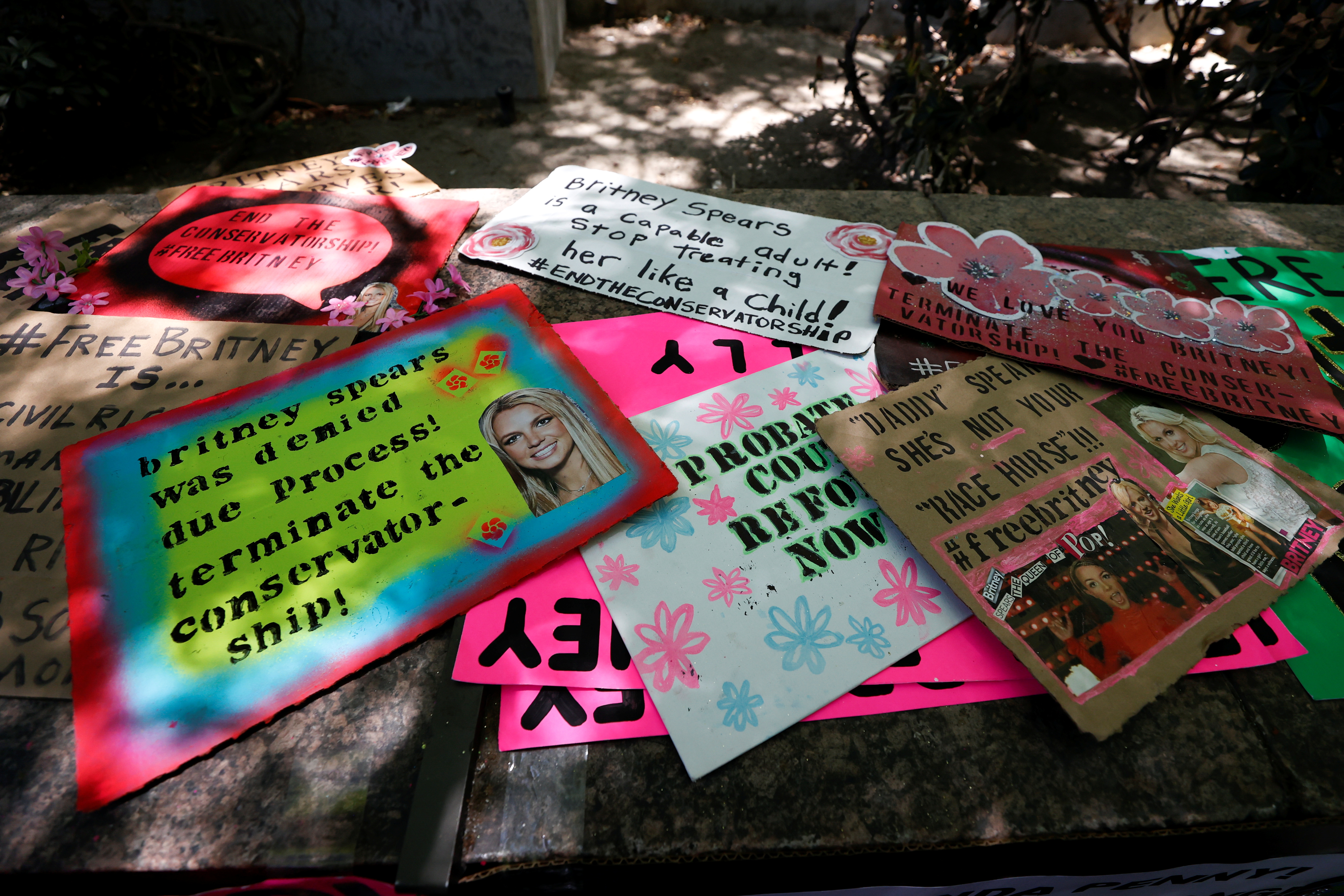 Placards are displayed during a protest in support of pop star Britney Spears on the day of a conservatorship case hearing at Stanley Mosk Courthouse in Los Angeles, California, U.S. June 23, 2021. REUTERS/Mario Anzuoni